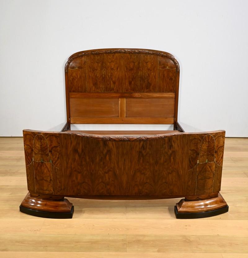 Ce lit en ronce de noyer, datant de la période Art déco des années 1930, est un véritable chef-d'œuvre d'ébénisterie.
Elegtics avec de délicates moulures florales, il incarne l'élégance et le raffinement de cette période artistique.
Les filets et