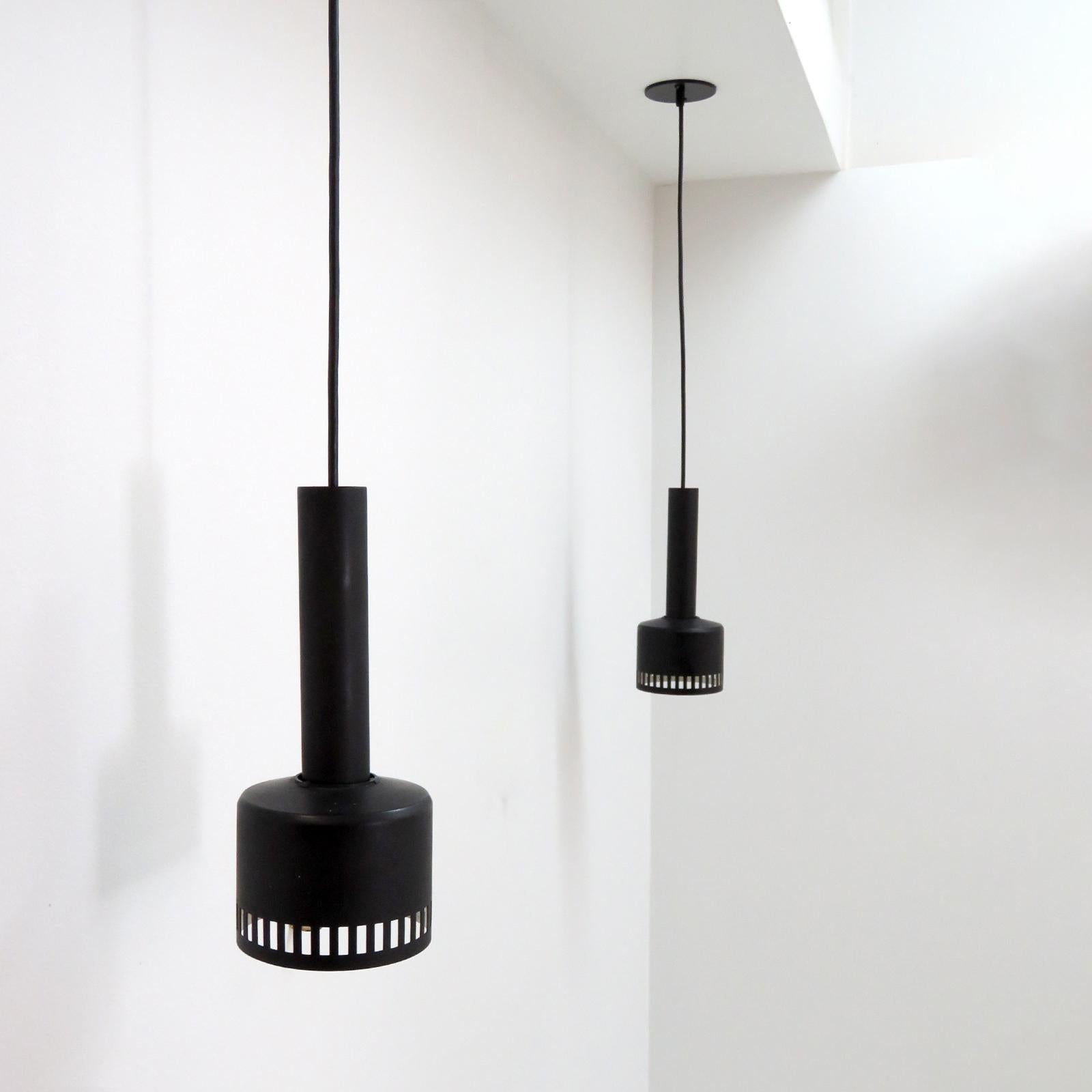 Minimalist Lita 2300 CF, France, pendant lights in matte black, with detachable perforated shade, total height can be adjusted per request, wired for US standards, one E26 socket per fixture, max. Wattage 75w each, bulbs provided as a onetime