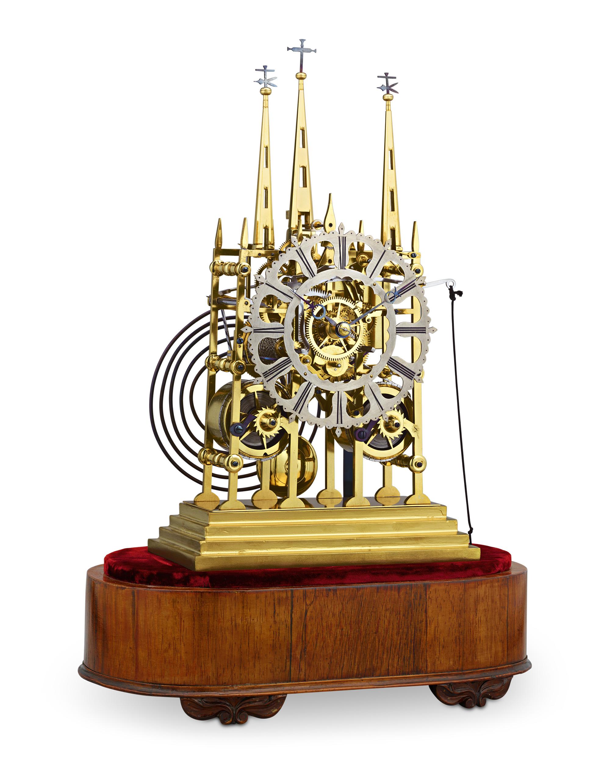 This remarkable English Litchfield Cathedral skeleton clock, crafted by Evans of Handsworth, captures the essence of the famed Lichfield Cathedral with its iconic three-spire top and stunning Gothic architecture. This extraordinary timepiece