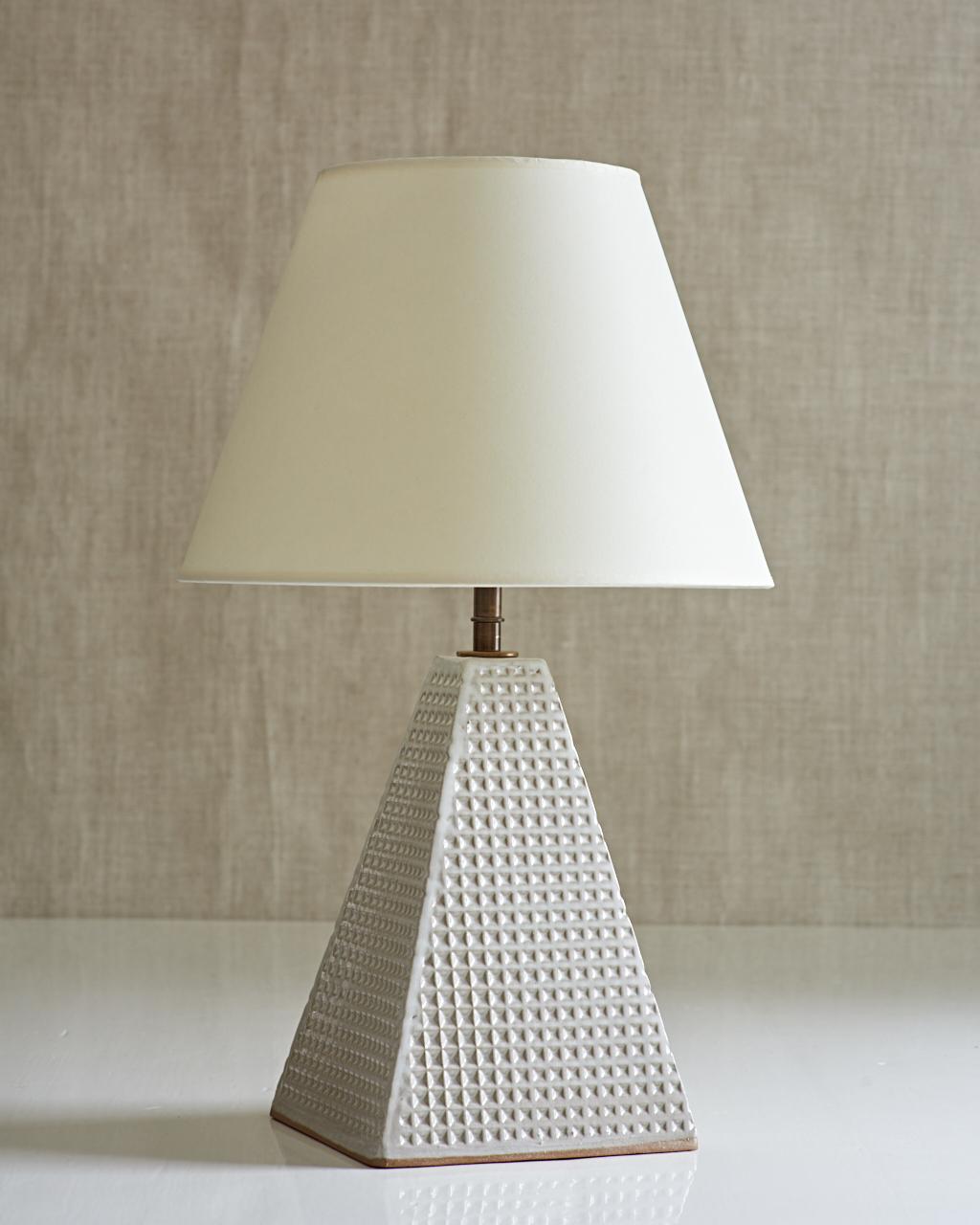 Handmade stoneware slab construction with waffle texture. Lamps are individually crafted and one of a kind.

White glaze with waffle texture. Antique brass fittings with braided black silk cord and off-white paper shade.

Measures: Steeple