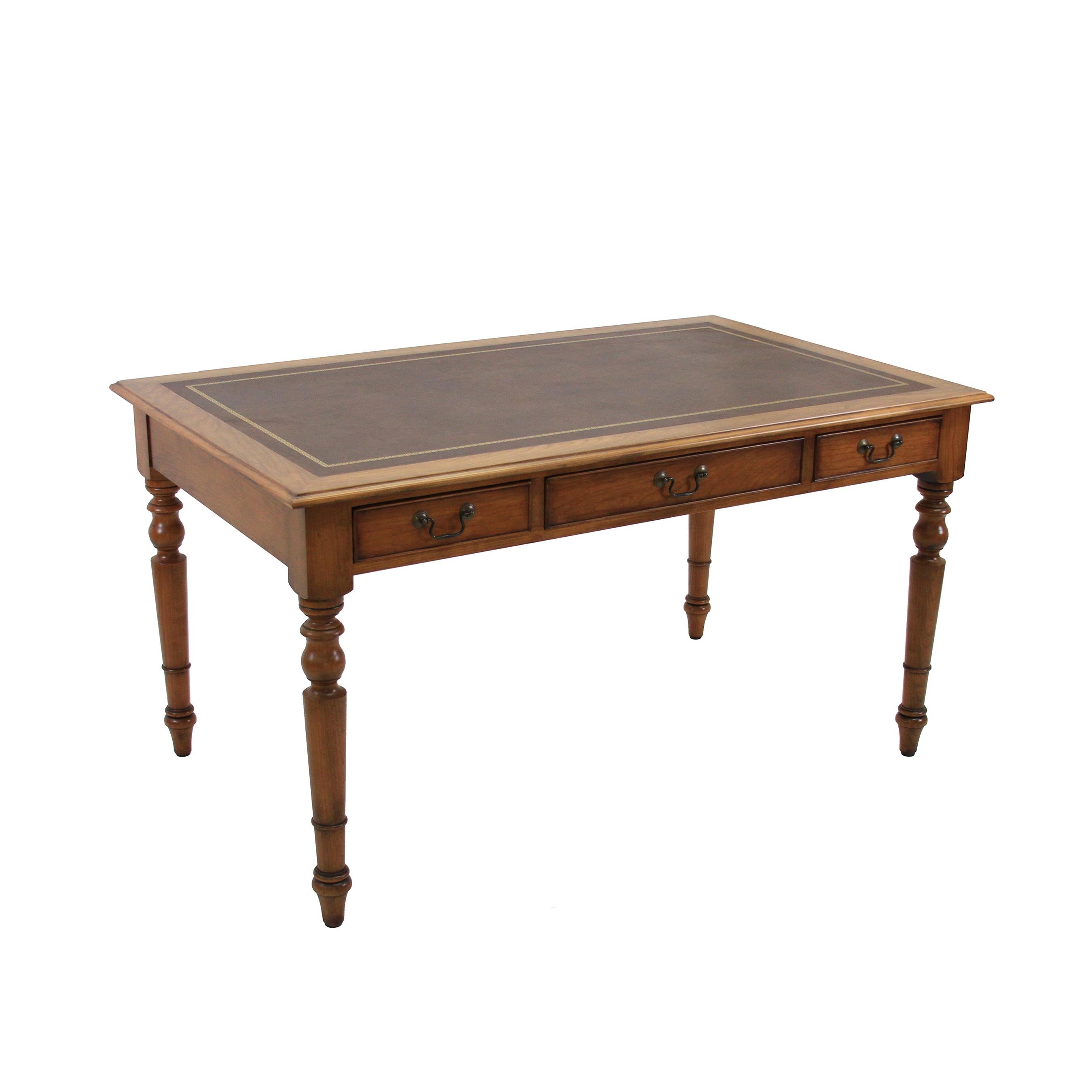 The solid cherry Litchfield writing desk has a gold embossed inlaid leather top with country farmhouse style legs and 3 cock beaded drawers with antique brass bail pulls. The leather can be customized as well as the leg style, hardware and size for