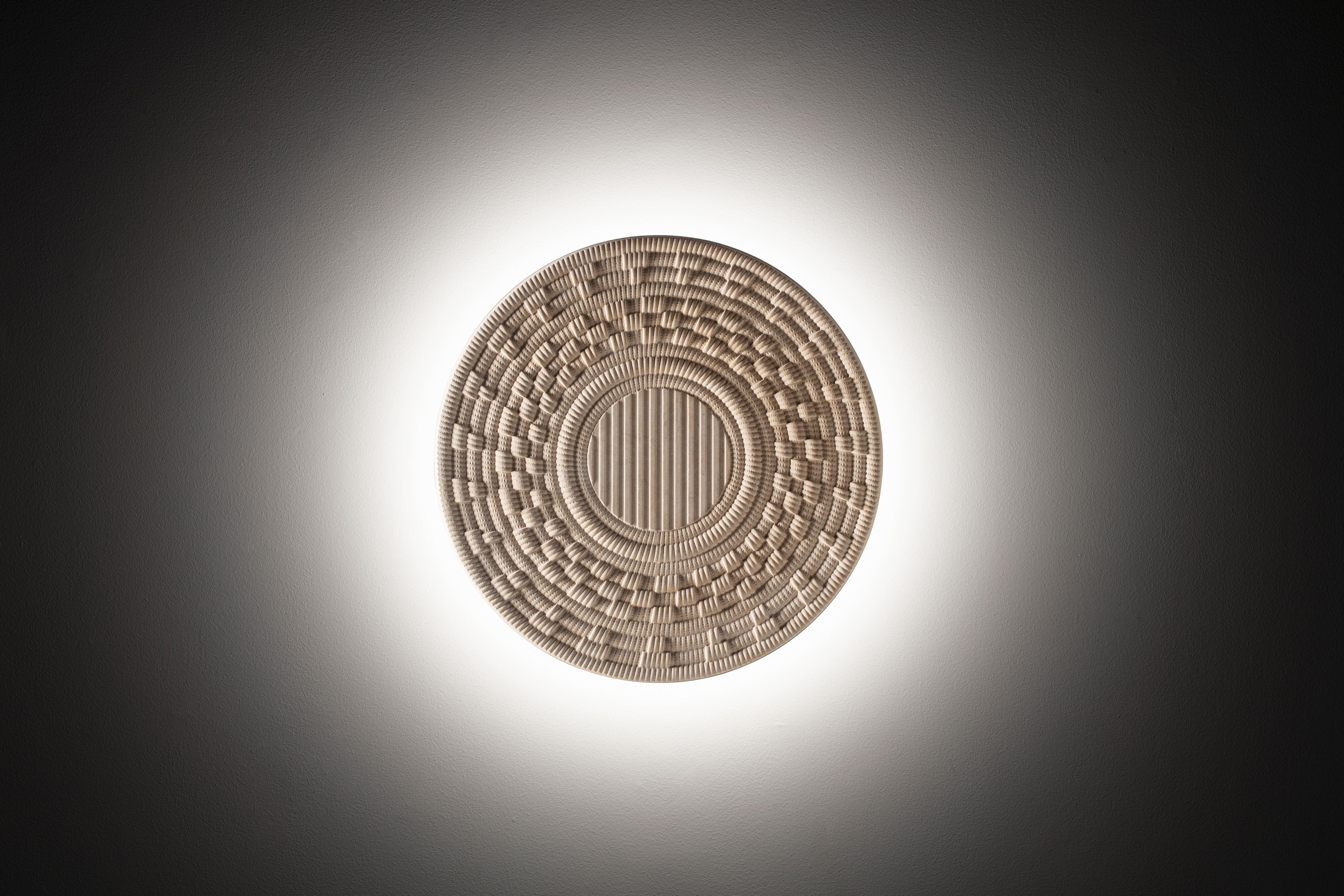 Corbulas 70
This superb, three-dimensional round panel is fashioned of Crema Tunisi stone. The pattern reproduced on the surface evokes the elaborate underside of traditional Sardinian baskets, used to hold and measure flour as well as colorful