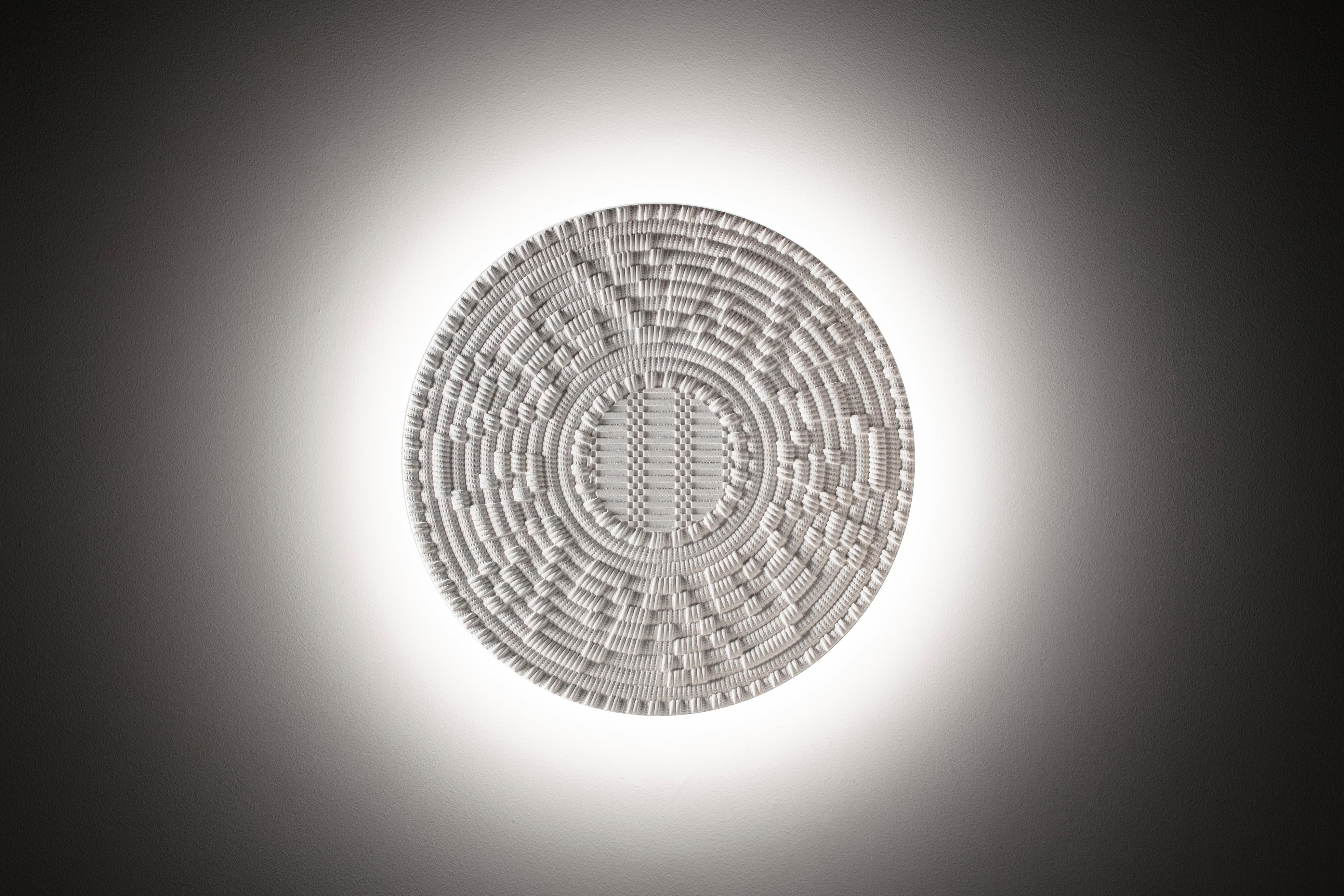 Corbulas 90
This superb, three-dimensional round panel is fashioned of Bianco Diocleziano marble. The pattern reproduced on the surface evokes the elaborate underside of traditional Sardinian baskets, used to hold and measure flour as well as