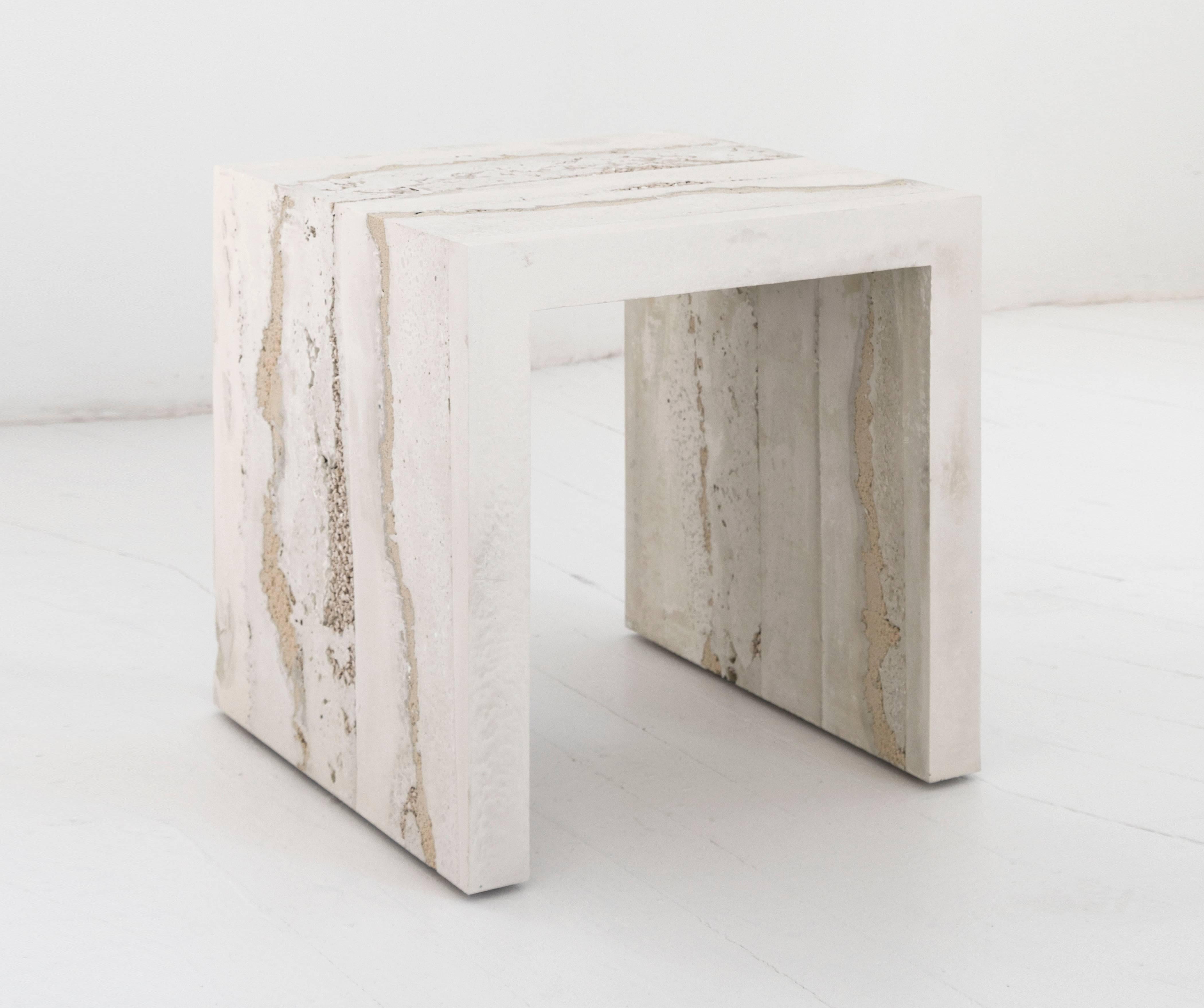 A layering of cement, porcelain, and sand, the made-to-order side table consists of gradients of tones and textures suggesting layers of earth. The hand-dyed granules are stratified with delicate veins and ombre effects to create an organic piece of