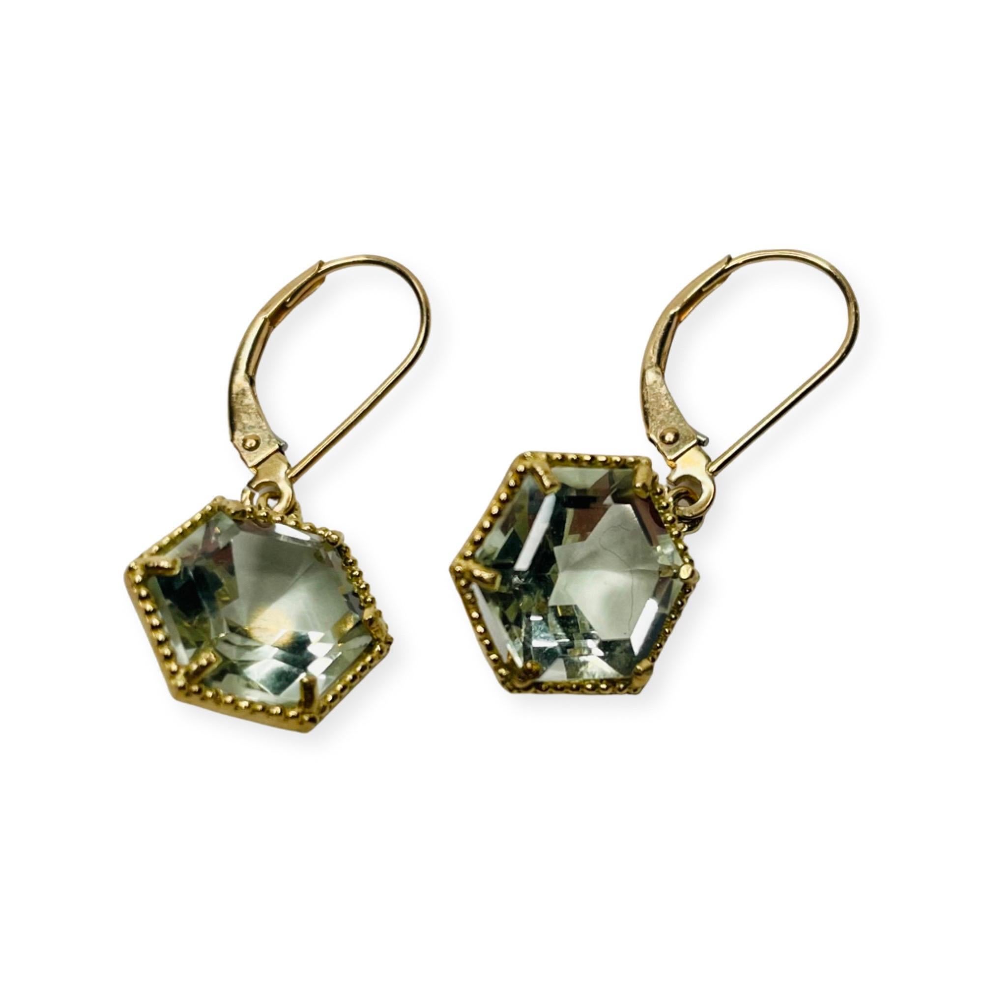 Lithos 14K Yellow Gold Green Amethyst Earrings. There is 7.0 carats of green amethyst. They are faceted in a hexagonal pattern and are prong set. They have milgraining around the outside. They have lever back closures.
400-70-818