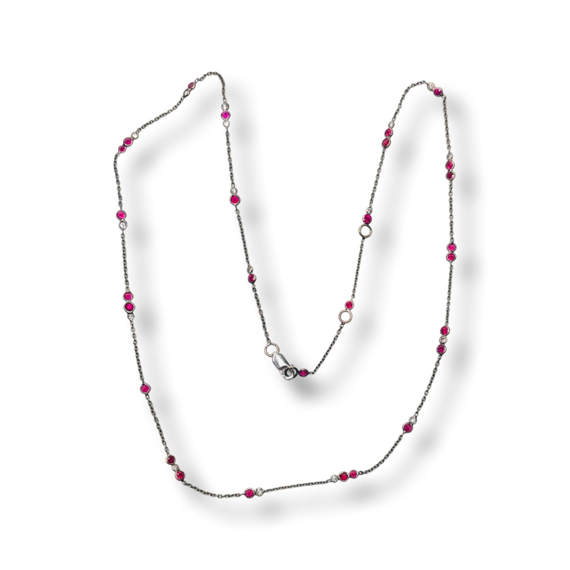 Lithos18K White Gold Black Rhodium Plated Necklace with Rubies & Diamonds. There are 28 Rubies for a total weight of 1.66 Carats. The rubies are a medium dark, vivid red in color. There are 17, full cut round brilliant diamonds, for a total weight