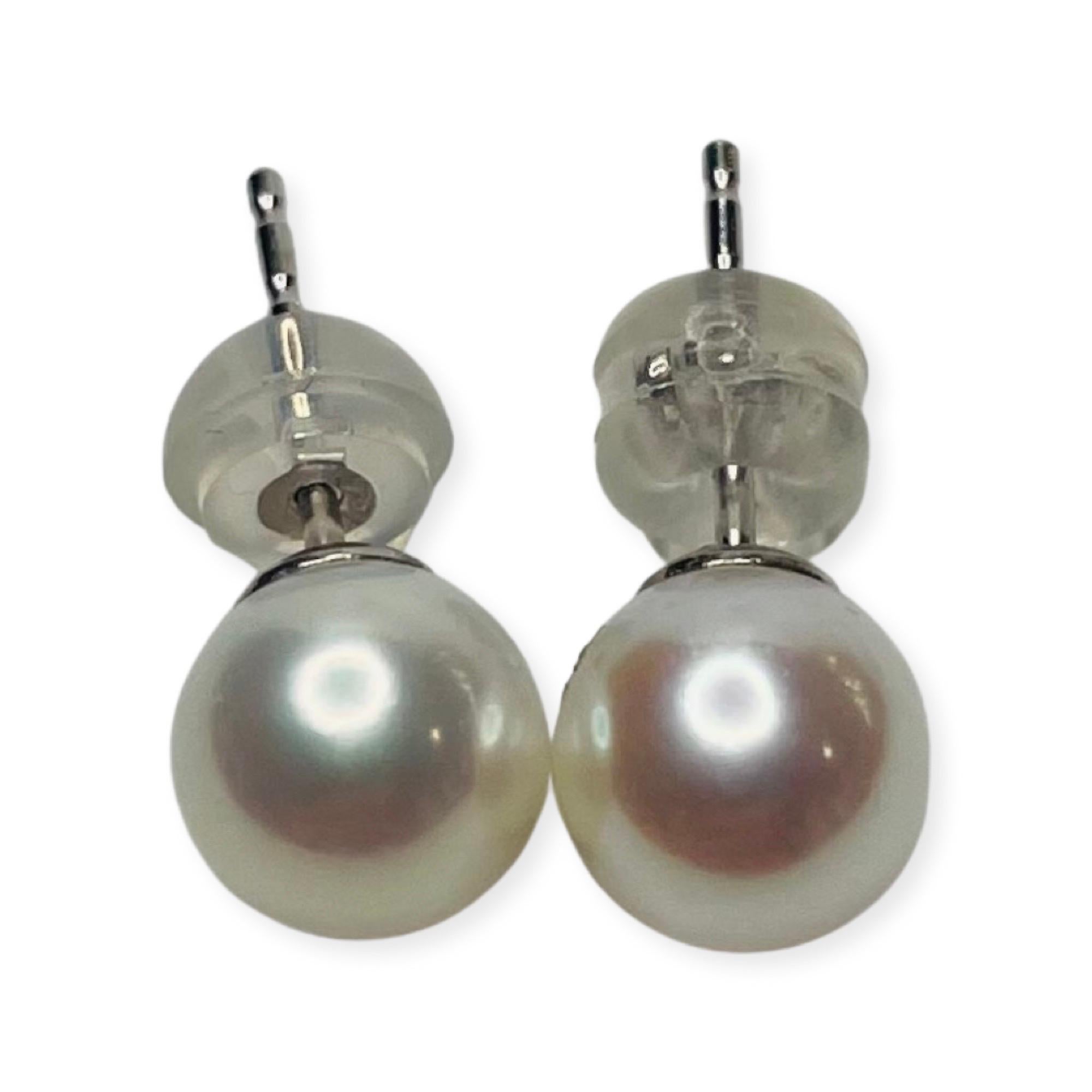 Lithos 18K White Gold Cultured Freshwater Pearl Earrings. The Pearls are 6.5 mm-7.0 mm.  The pearls are round with slight blemishes and high luster. They have a rose overtone. These are Stud earrings with 18KW posts and 14KW backs embedded in