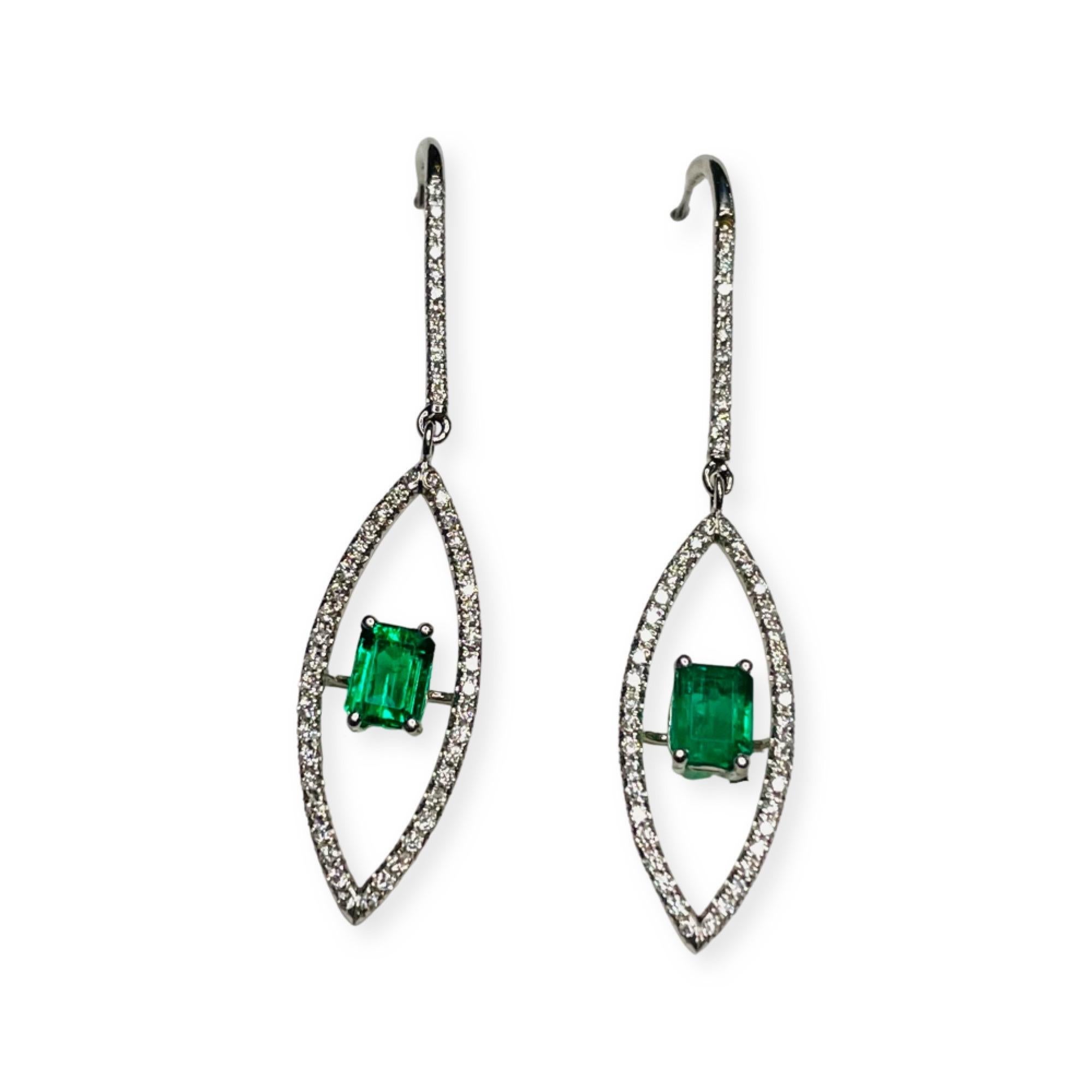 Lithos 18K White Gold Diamond & Emerald Earrings.  Each earring has a natural emerald. One is 0.58 carats and measures 5.26 mm x 4.5 mm 3.28 mm. The other emerald is 0.502 carats and measures 5.37 mm x 4.02 mm x 2.95 mm. This emerald has an AGL cert