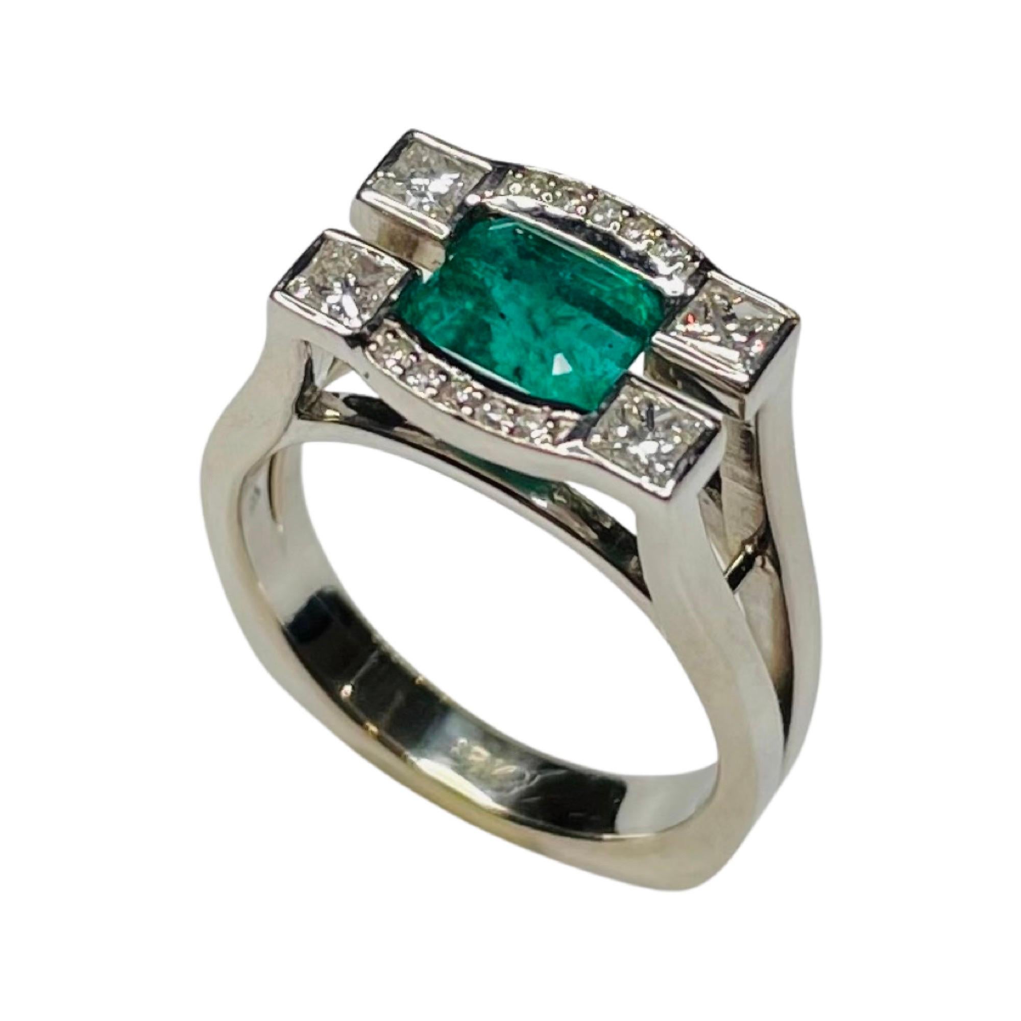 Lithos 18K White Gold Emerald and Diamond Ring. The natural emerald is channel set. It weighs 1.38 carats, It measures 6.38 mm x 5.92 mm x 4.87 mm, It has an AGL Cert # 49343. There are 10 full cut round brilliant diamonds, bead set, for a total