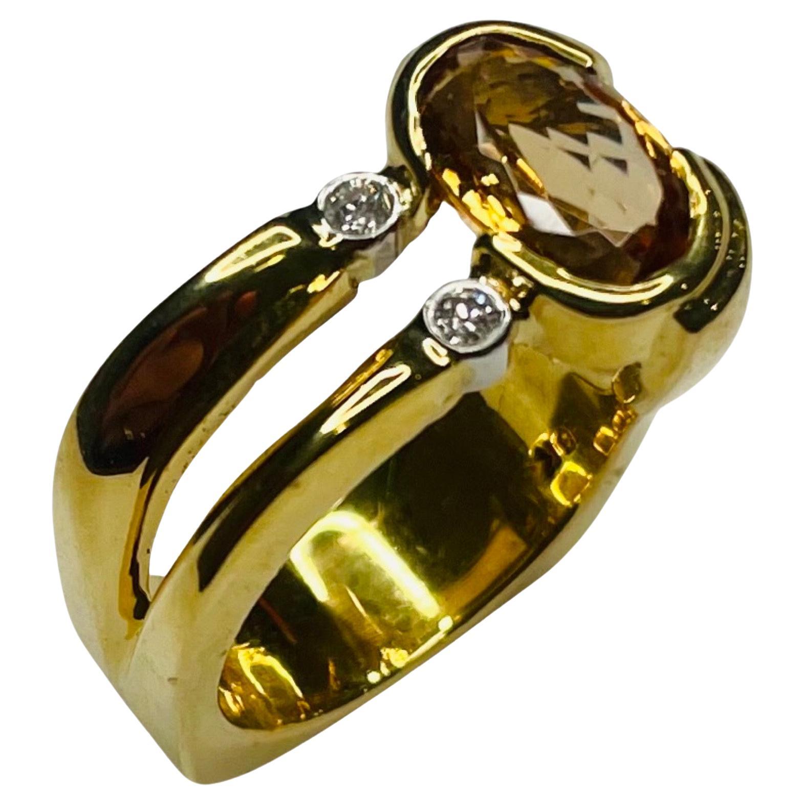 Lithos 18K Yellow Gold and Platinum Golden Topaz and Diamond Ring. There are 2 full cut round brilliant diamonds bezel set in platinum. They are 0.102 carats. They are VS clarity of G color. The golden topaz is 3.67 carats. The top of the ring is