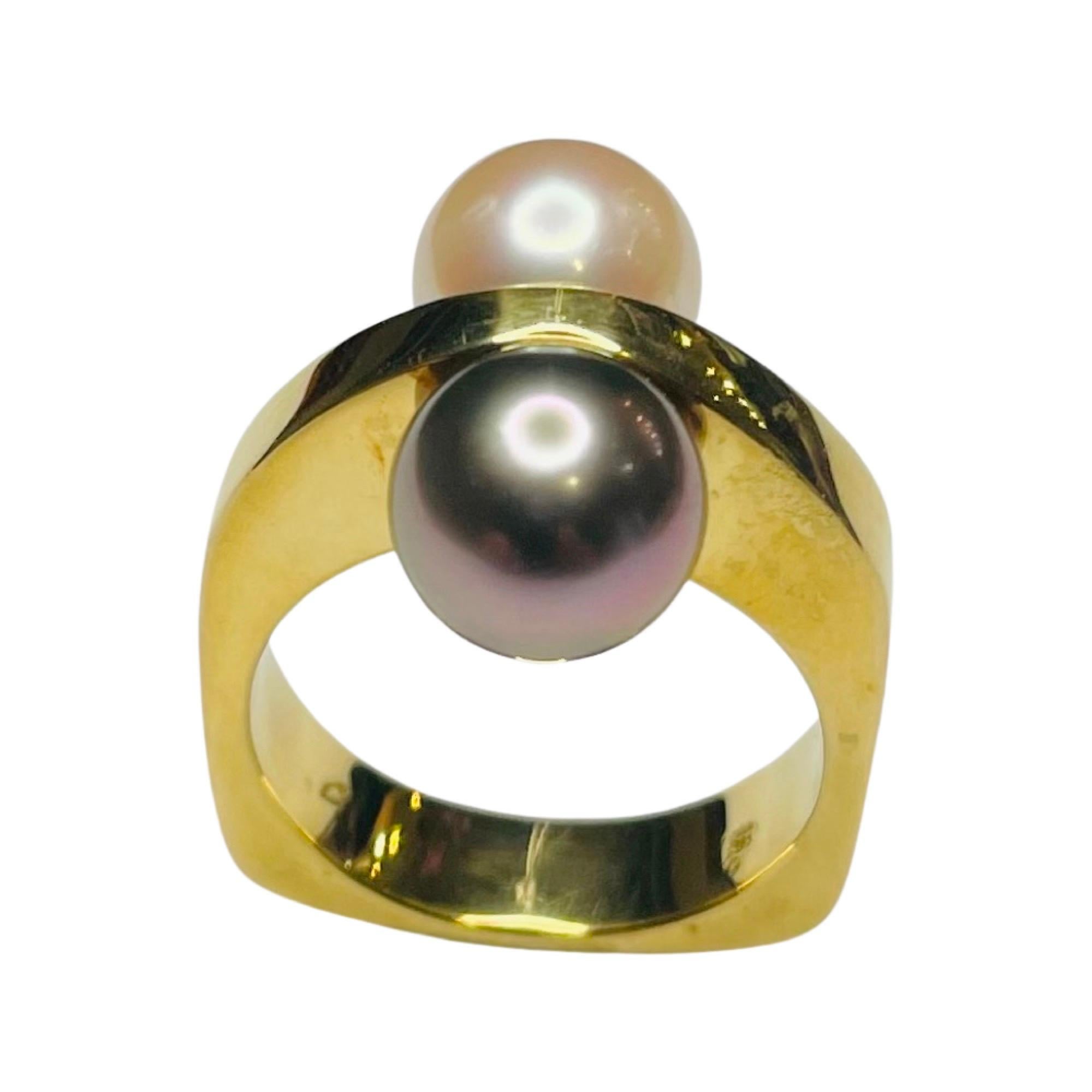 Lithos 18K Yellow Gold Cultured Natural Color Black Tahitian Pearl and White Japanese  Akoya Pearl Ring. The Black Tahitian pearl is 8.89 mm. This pearl is round with slight blemishes and a rose/poe rava overtone. The Akoya pearl is 8.52 mm. This