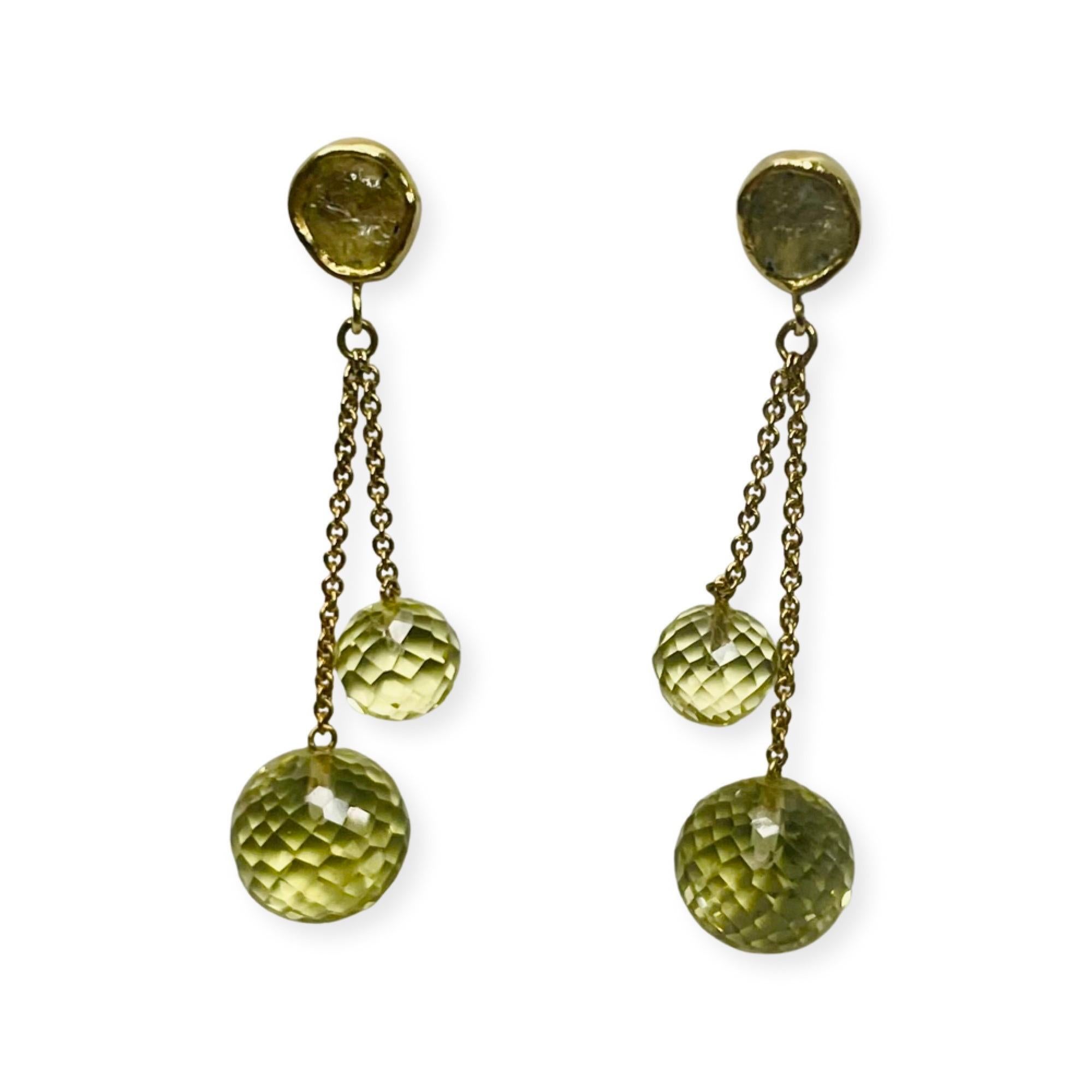 Lithos 18K Yellow Gold Montana Sapphire Rough and Faceted Peridot Earrings. There is a total rough Montana sapphire weight of 1.41 carats. They are bezel set in 18KY gold. The four, peridot faceted balls, dangle on 1.0 mm 18KY gold cable style