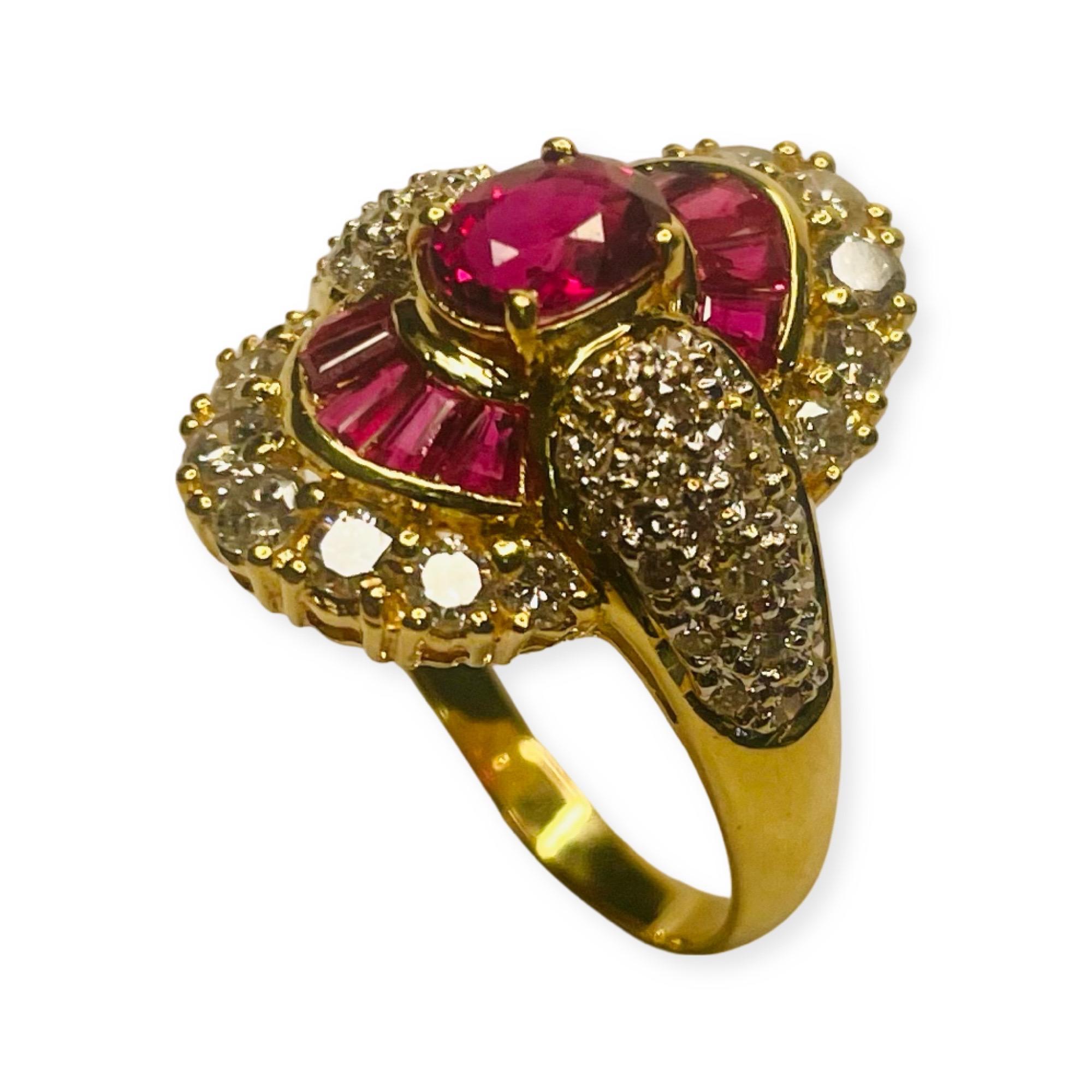 Lithos 18K Yellow Gold Ruby and Diamond Ring. There is a 1.01 carat, natural ruby, prong set in the center of the ring. The ruby measures 6.39 mm X 4.76 mm X 3.3 mm.  There are 10 baguette cut rubies, channel set above and below the center ruby. 