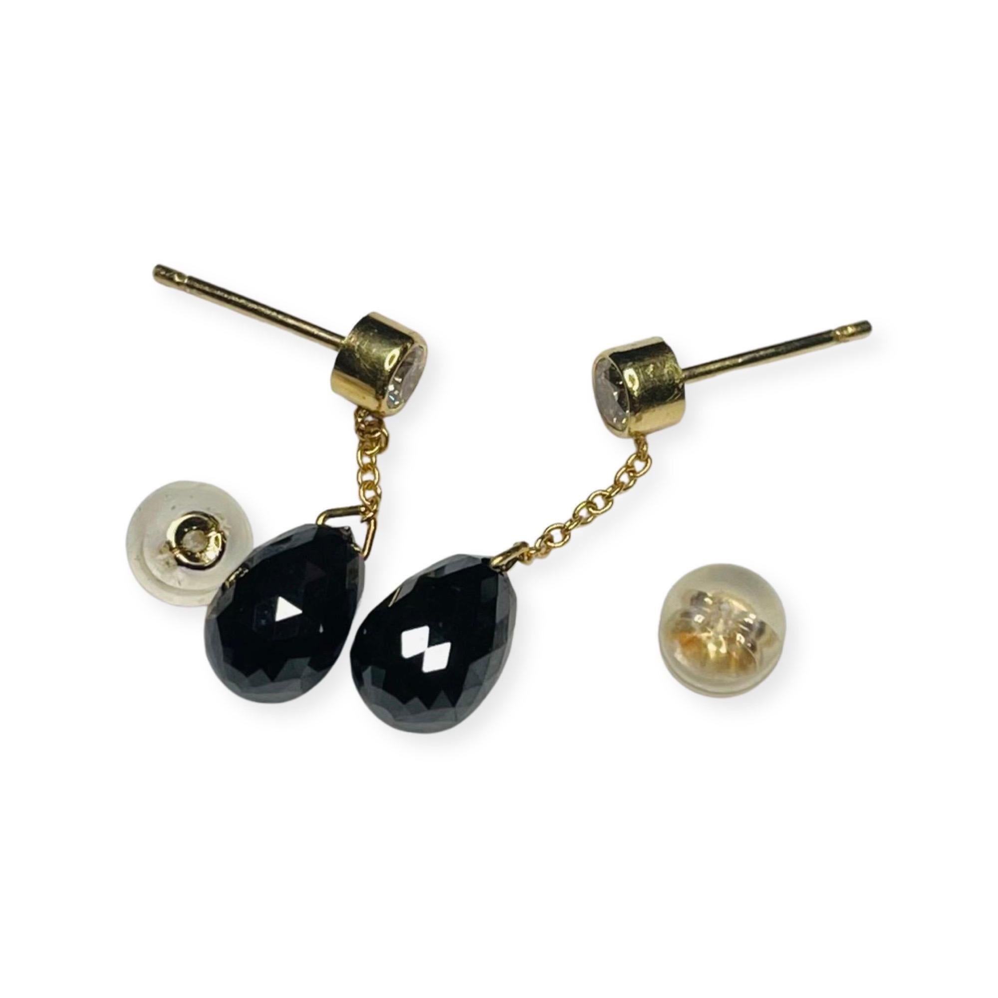 Lithos 18K Yellow Gold Black Diamond Briolette Drops on White Diamond Stud Earrings. There are 2, full cut round brilliant diamonds, bezel set in 18K white gold.  There is a total white diamond weight of 0.315 carats. They have posts and silicon ear