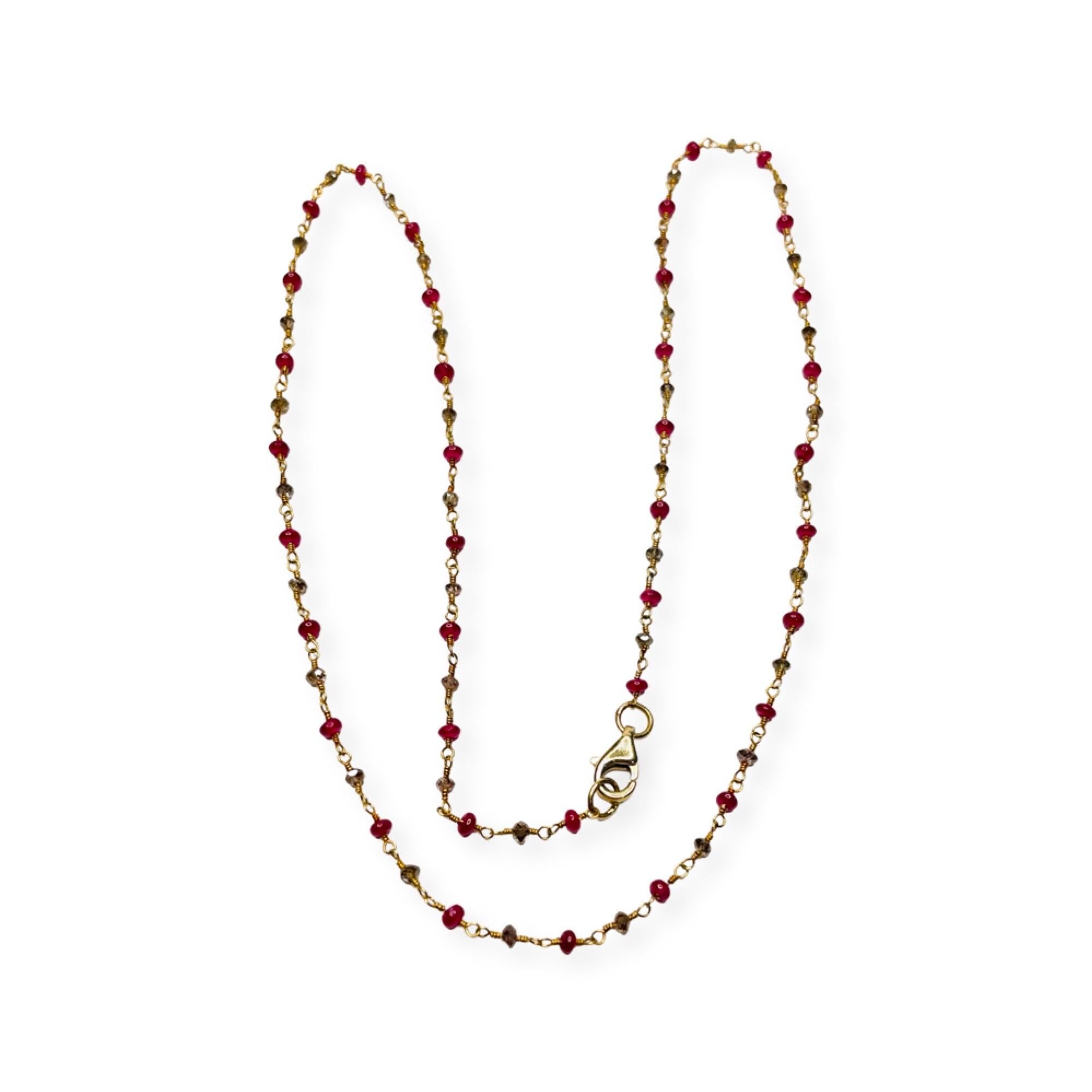 Lithos 18K Yellow Gold  Ruby Bead and Natural Color Brown Diamond Necklace. The handmade chain has a wire that runs through the rubies and diamonds.  The wire twists at each end and connects with a ring. There are ruby beads and faceted diamond
