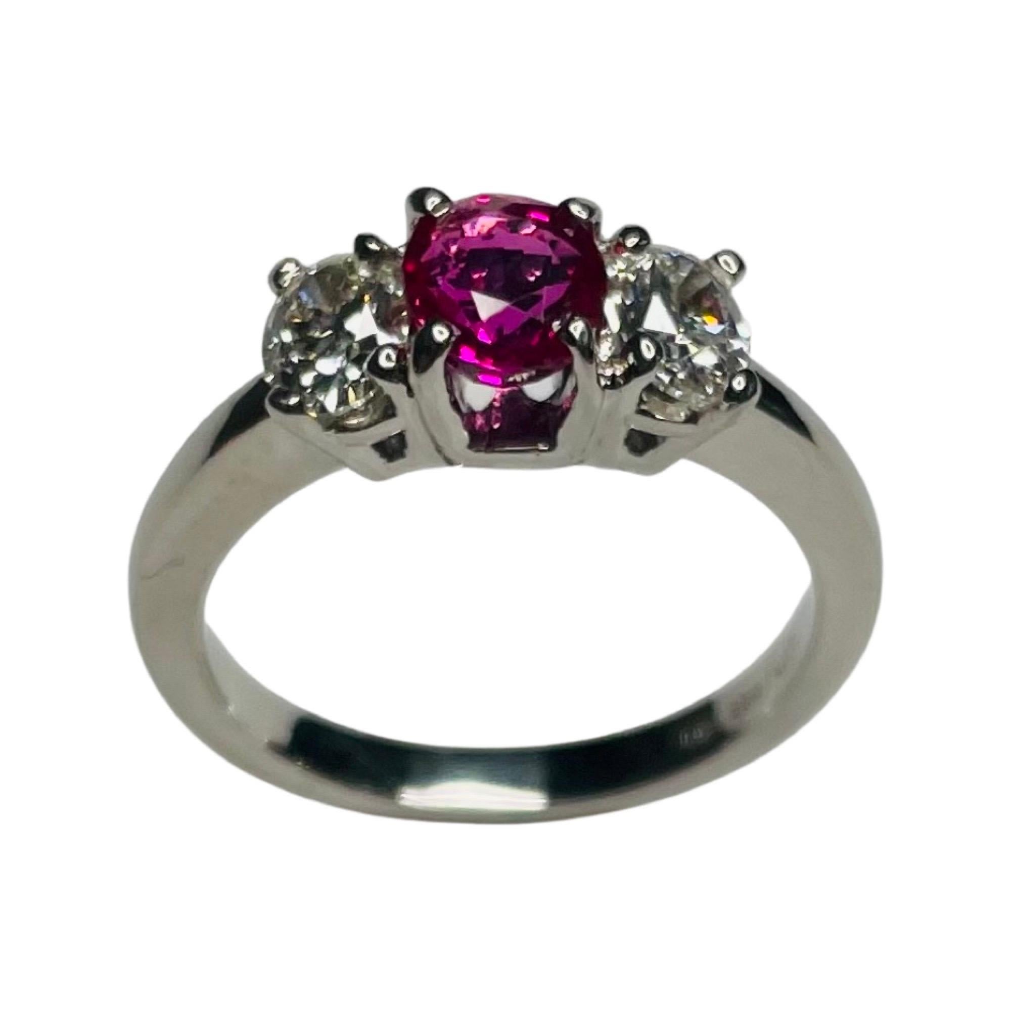Lithos Platinum, Diamond and Ruby 3 Stone Ring. The Ruby is 1.09 carats. It has an AGL certification # GB46053. It measures 6.09 mm X 5.04 mm X 3.38 mm. It is a medium, vivid, slightly purplish red in color. It has been heat treated. The two oval