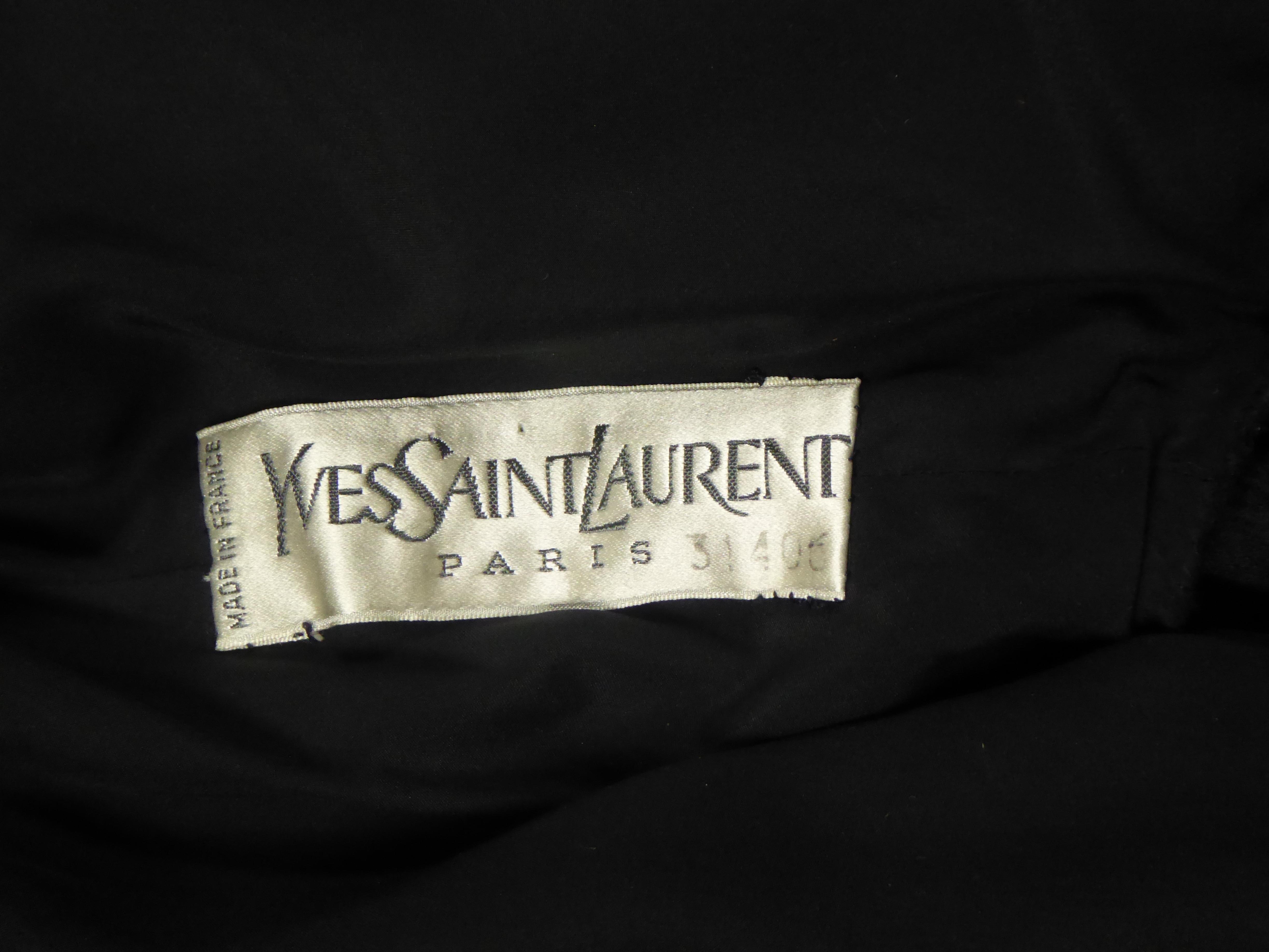 Circa 1973

France

Iconic Yves Saint Laurent Haute Couture little black dress numbered 34406 and dating from the 1970s. Straight cut, slightly flared at the bottom, large oval neckline and long sleeves in slightly stretchy blistered jersey. Cuffs,