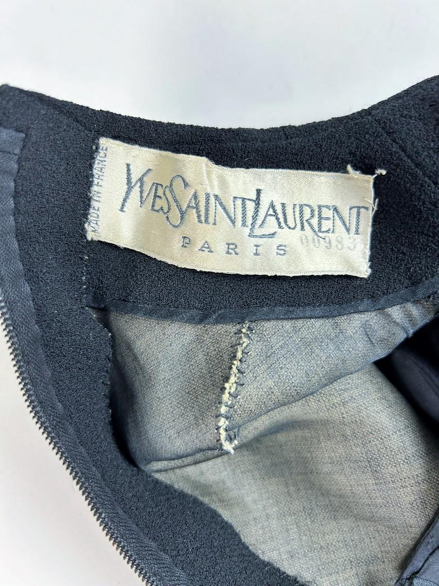Circa 1964-1965

Paris

Little black dress in Grain de Poudre, muslin and leather by Yves Saint Laurent Haute Couture numbered 00983 in the tradition of the famous Mondrian dresses made by the French master in 1965.  A straight, sleeveless,