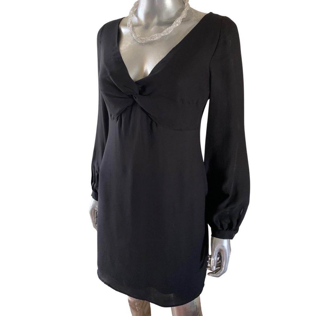 From our “Little Black Dress”  collection, This Valentino Roma dress goes from day to evening with ease. Picked from a Palm Springs Fashionista’s closet NWT and never worn. The fluid black silk blend fabric drapes in a knot under the bust, with a