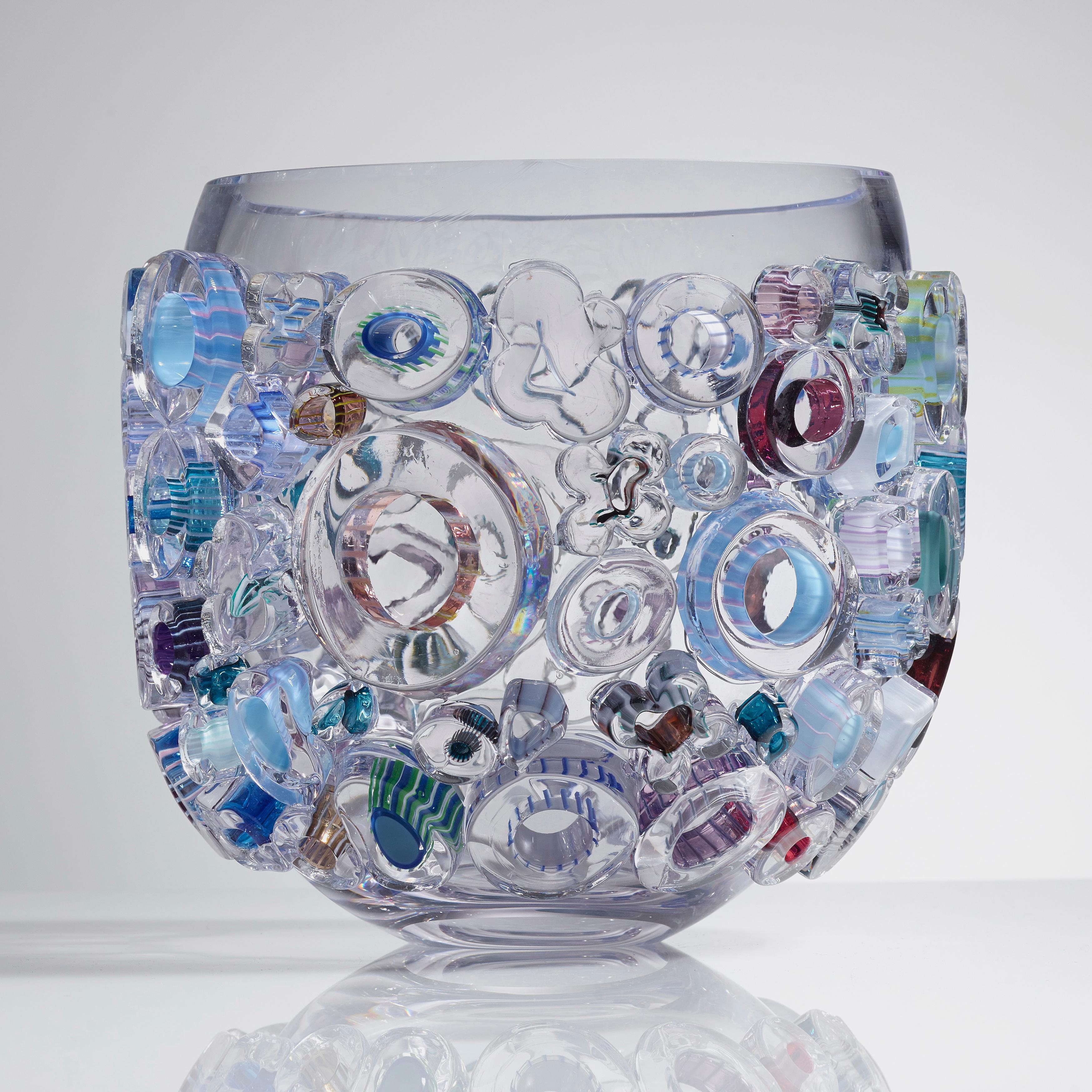 Little Common Ray Blue is a unique handblown and crafted vase & artwork / bowl / centrepiece by the German artist, Sabine Lintzen. The initial inner form is free-blown in clear glass and adorned with various individually shaped murrini, all created