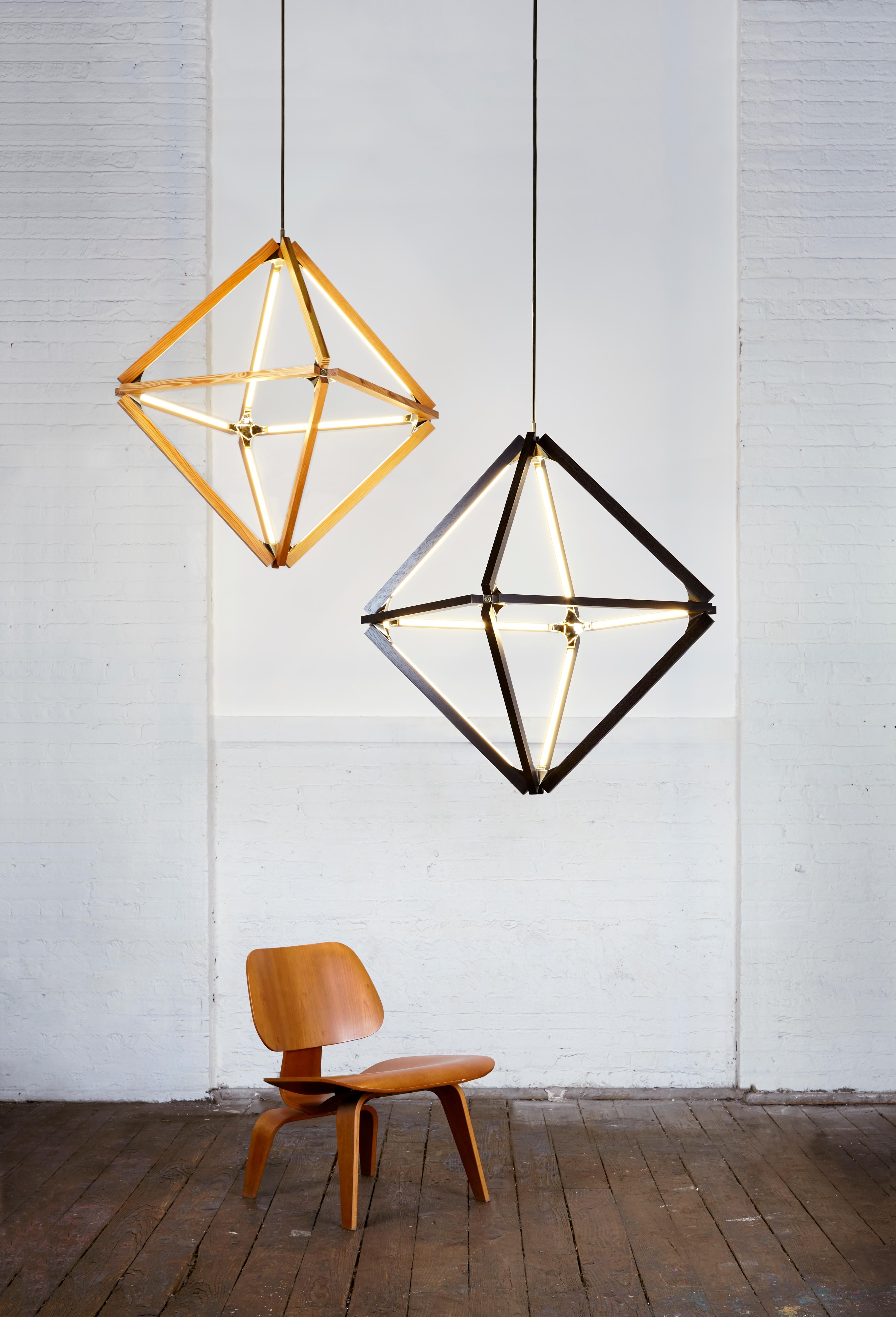Diamond chandeliers is a continued exploration into the timeless appeal of octahedral and hexagonal forms in nature. Stickbulb takes this classical form in a new direction by using its signature wooden bulb to echo the shape of the prized gemstone.