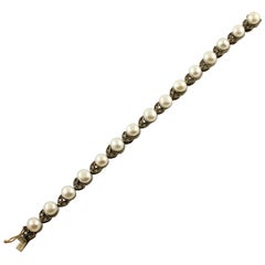 Bracelet à maillons en or rose et argent avec petits diamants blancs, thème fleuri