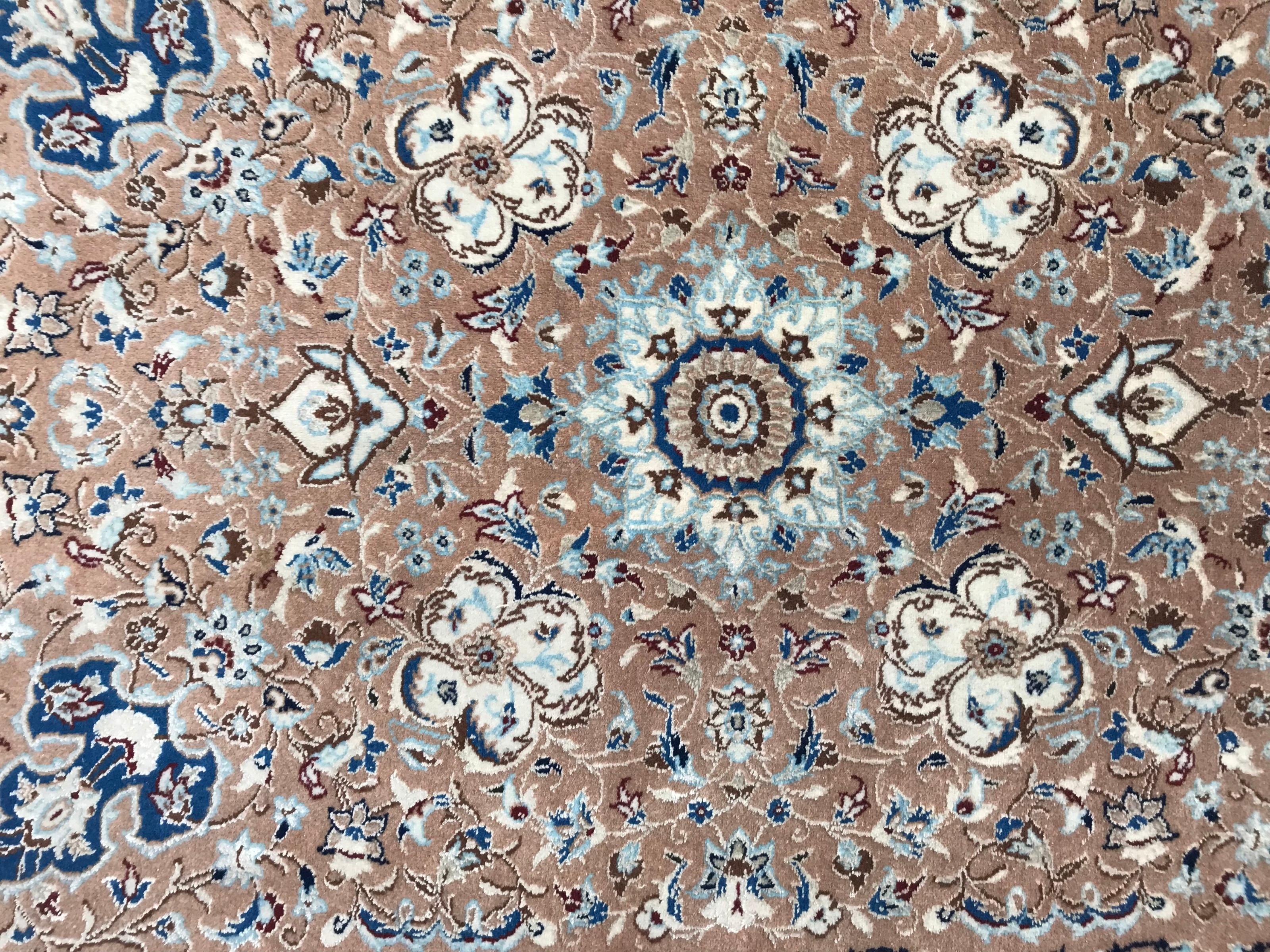 Very beautiful and fine vintage rug entirely and finely hand knotted with nice floral design and blue and beige colors, wool velvet on cotton foundation.