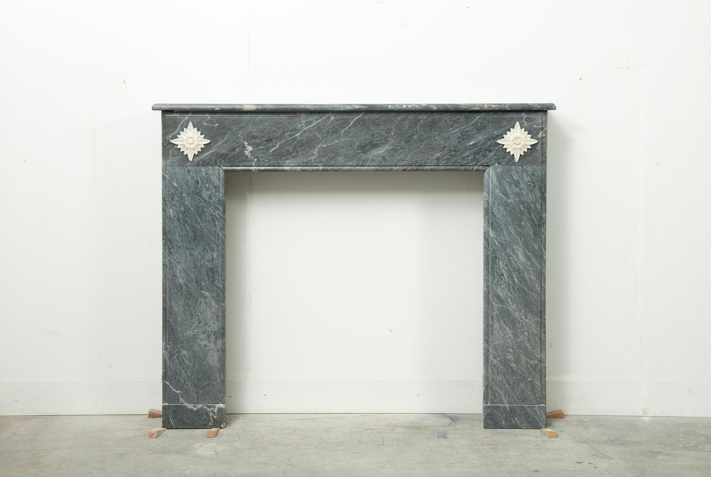 Little Grey Marble Louis XVI Fireplace Mantel

Nice and decorative mantelpiece executed in Bardiglio Grey marble with white Carrara Marble floral decorations.

The nice rounded topshelf show the perfect amount of age the shelf rests on a profiles