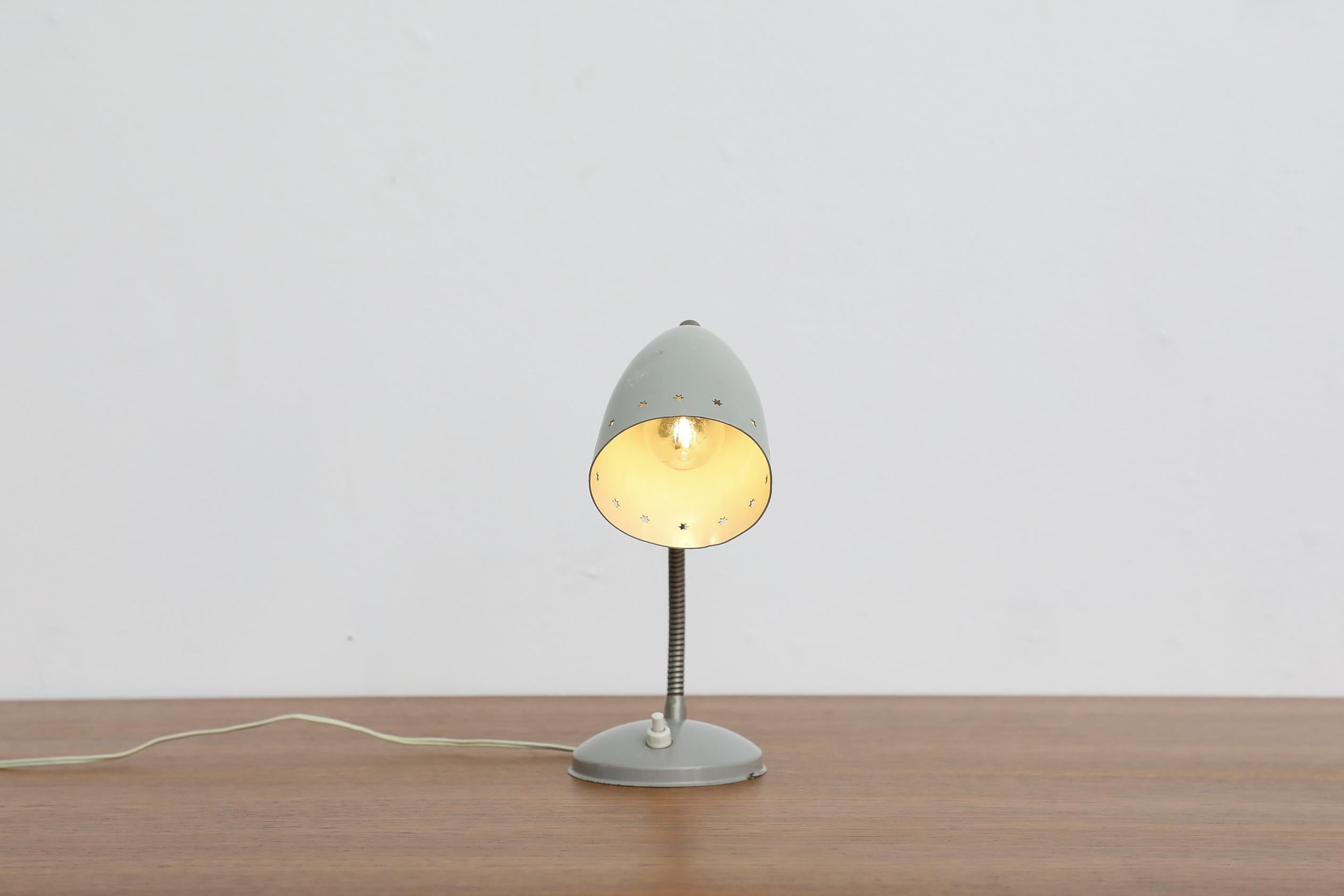 Mid-Century, very appealing little grey enameled reading lamp with tiny little cut-out stars around the shade by Hala Zeist, 1950-1960, Netherlands. In original condition with visible wear, including scratches and some possible denting. Wear is