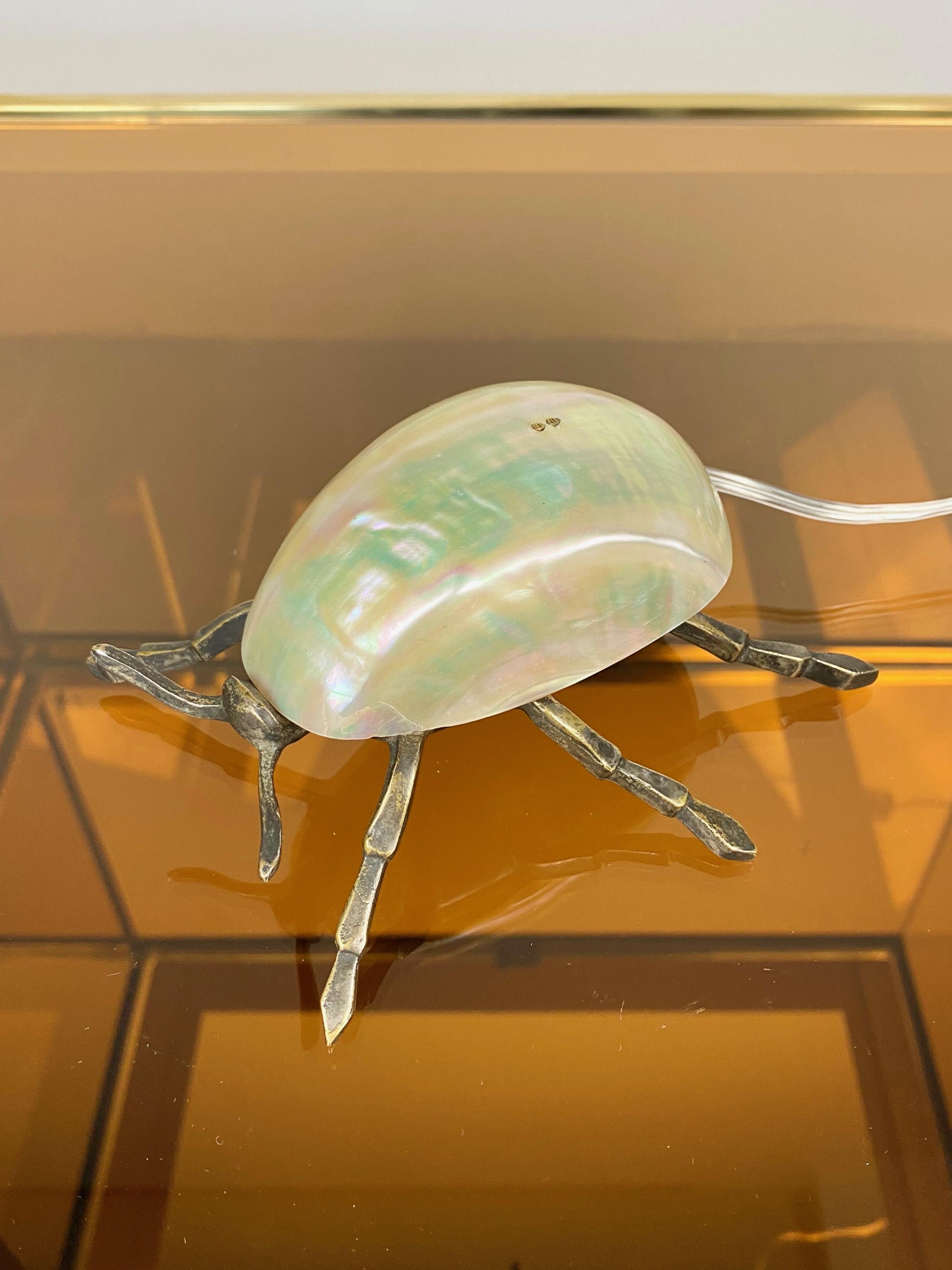 Little lamp in the shape of an insect with mother of pearl shell and iron legs, Italian piece of the 1970s. 
The electric wiring is new.