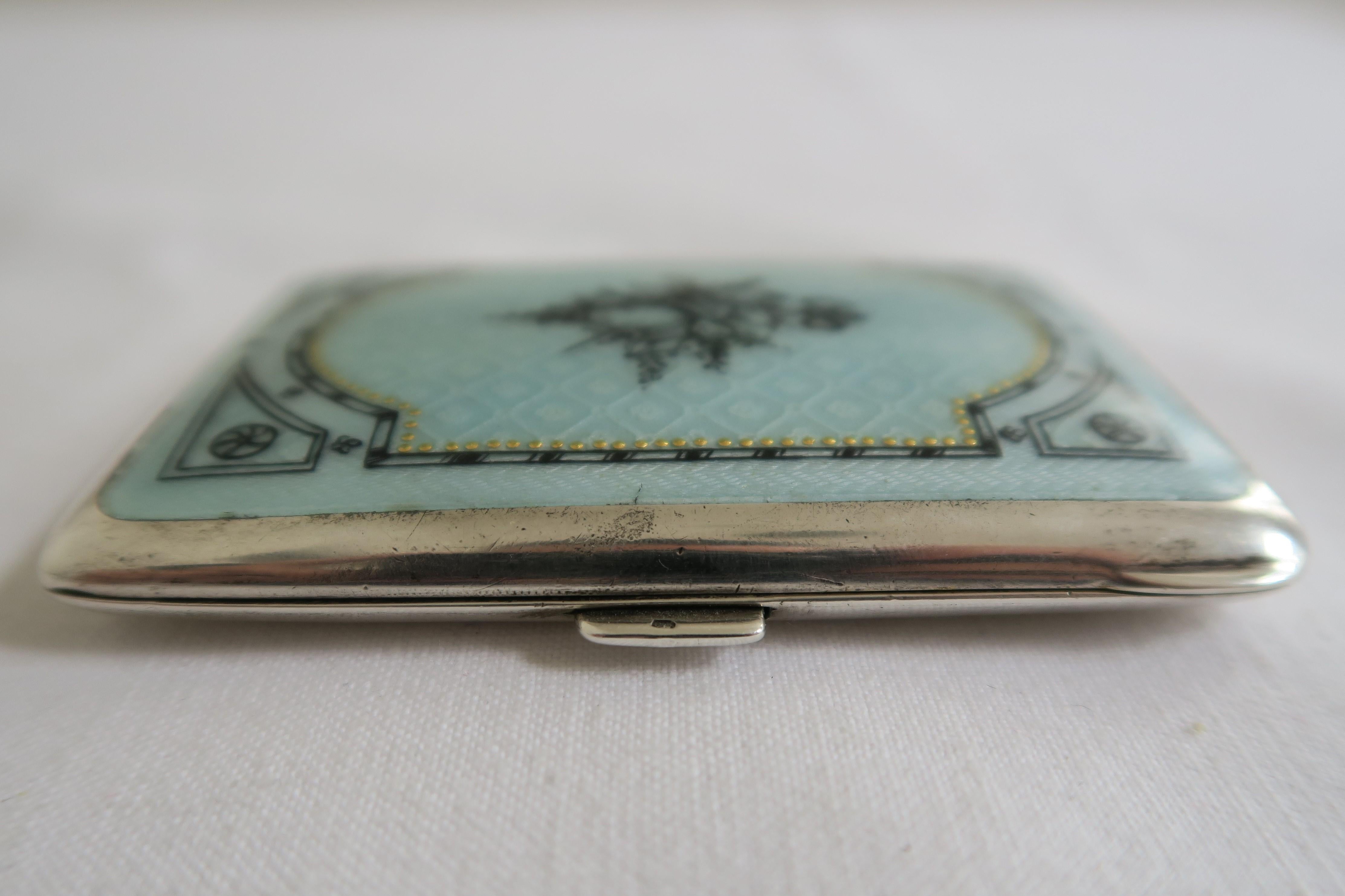 For sale is a delicate little cigarette box. It is made from 900/1000 silver stamped L/R. The inside is gilded and shows the German hallmark of half moon and crown. The lid is embellished with turquoise enamel, covered in hand painted white floral