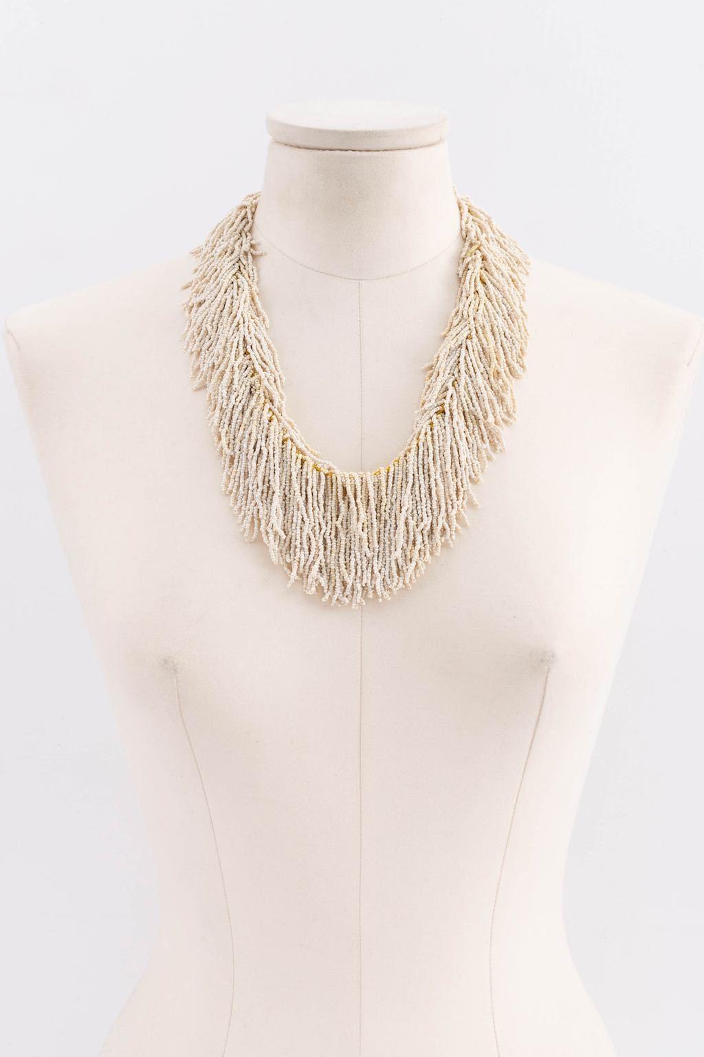 Necklace made of little white glass beads forming fringes. Not signed, this piece is from the mid 1920s.

Additional information: 
Condition: Very good condition
Dimensions: Length: 53 cm (20,87 in) - Width: 6 cm (2,36 in)

Seller Reference: BC144