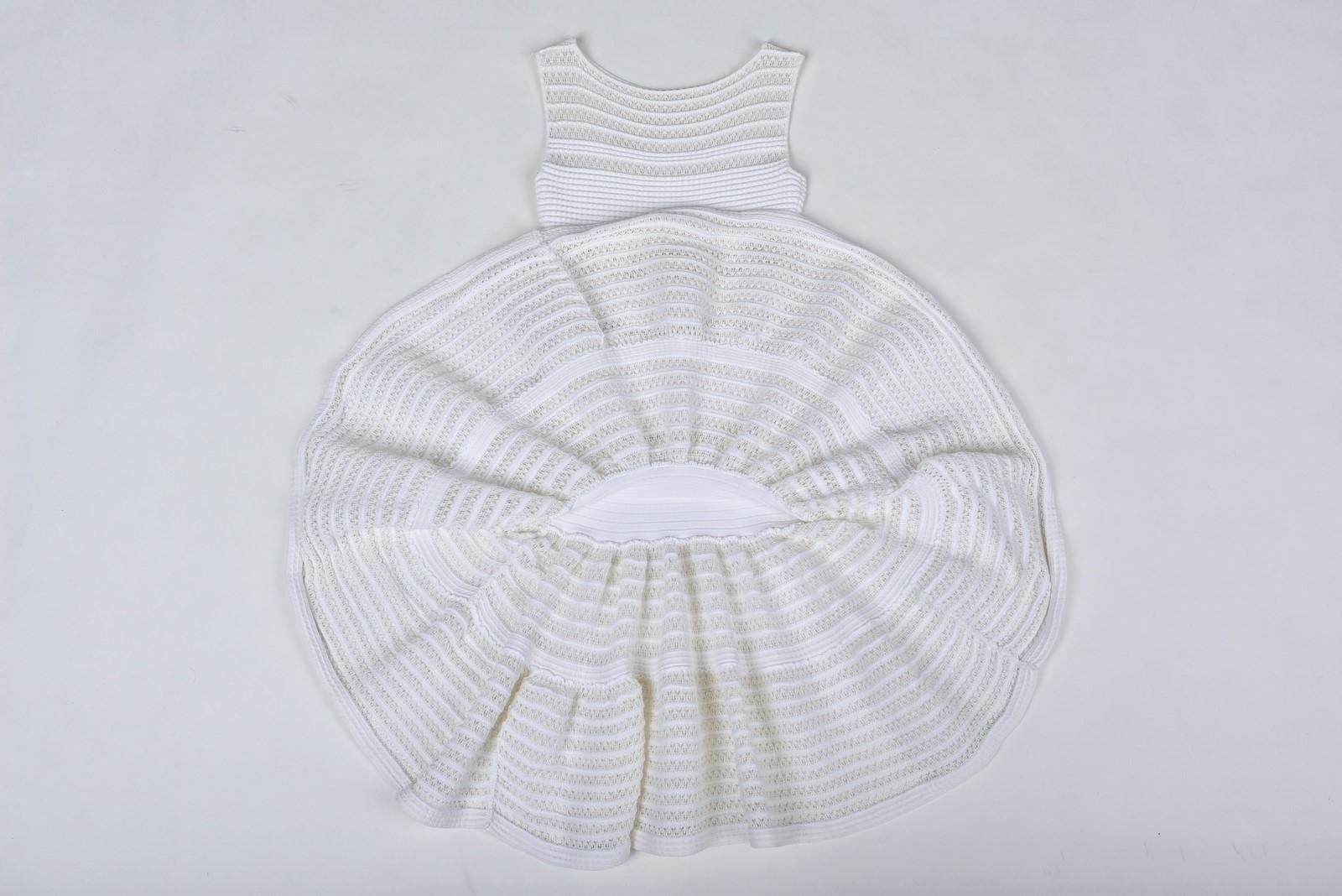 Circa 2000

France

Little white stretch dress by Azzedine Alaïa dating from the 2000s. Iconic sleeveless mini-dress, boat neckline in polyamide and cotton with lace interlacing sculpting the silhouette. Zip on the side and effect blousant of the