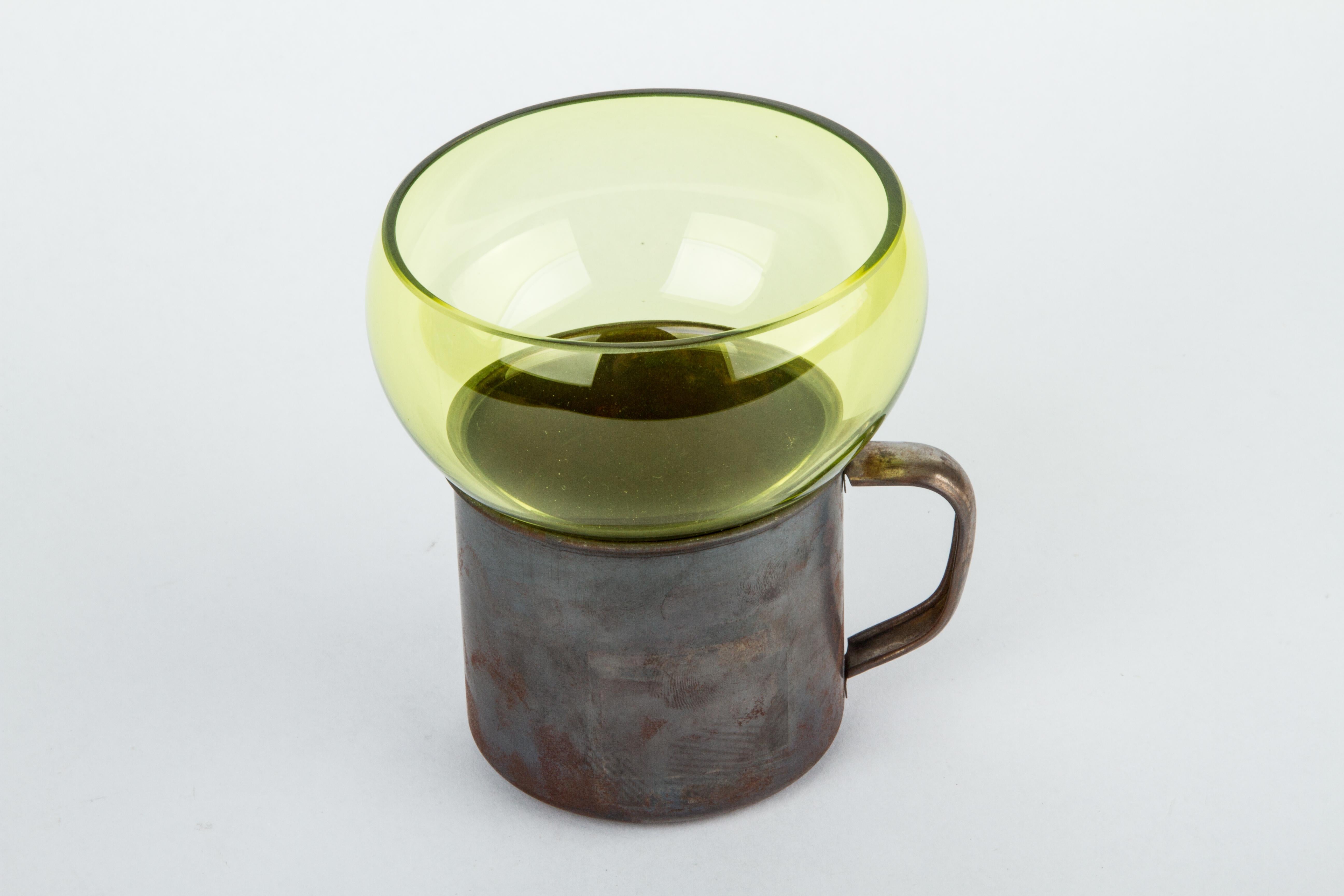 This unique piece is part of the Out of the Cage Collection, a project that was born experimentally in Mexico 11 years ago. 
Liquid glass is blown into various shapes and sizes of “molds” such as birdcages, mugs or baskets. The final object is the