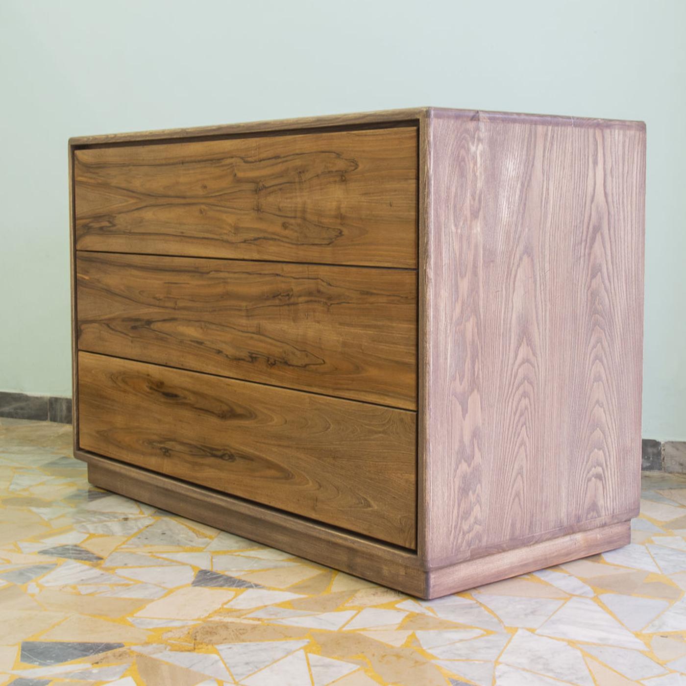 The sober and clean lines of the Liv Dresser reveal an impeccable construction designed by Erika Gambella and crafted by expert artisans with traditional cabinet-making techniques. Raised on a recessed base with leveling feet, the sturdy ash wood