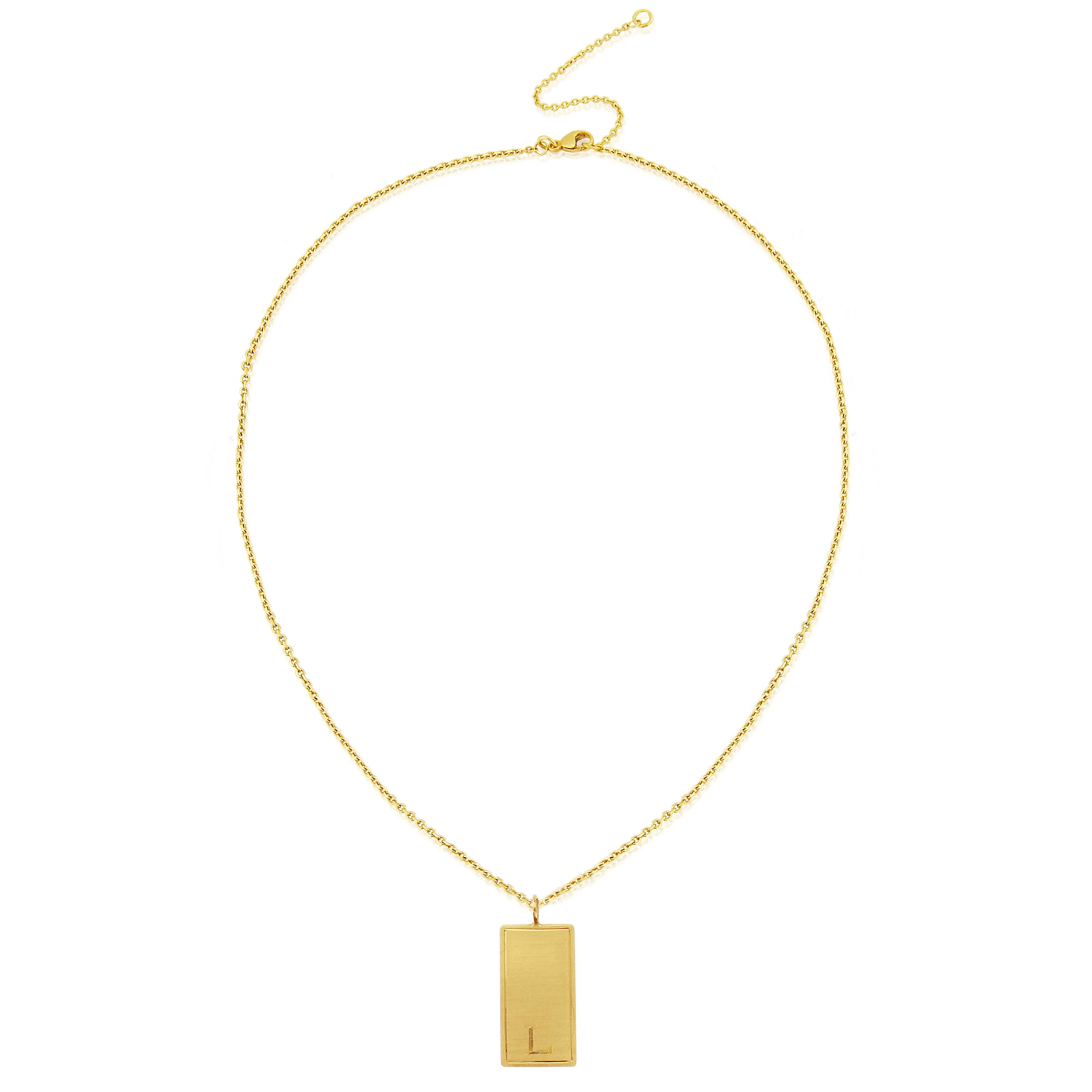 Your initial is engraved by hand on to this elegant take on a classic ID tag.

Each tag is made in London by hand and is available in dipped in 18 karat yellow gold vermeil, rose gold vermeil and Eco Silver.
 
Tag 0.8cm x 2.7cm Chain extendable 40 -