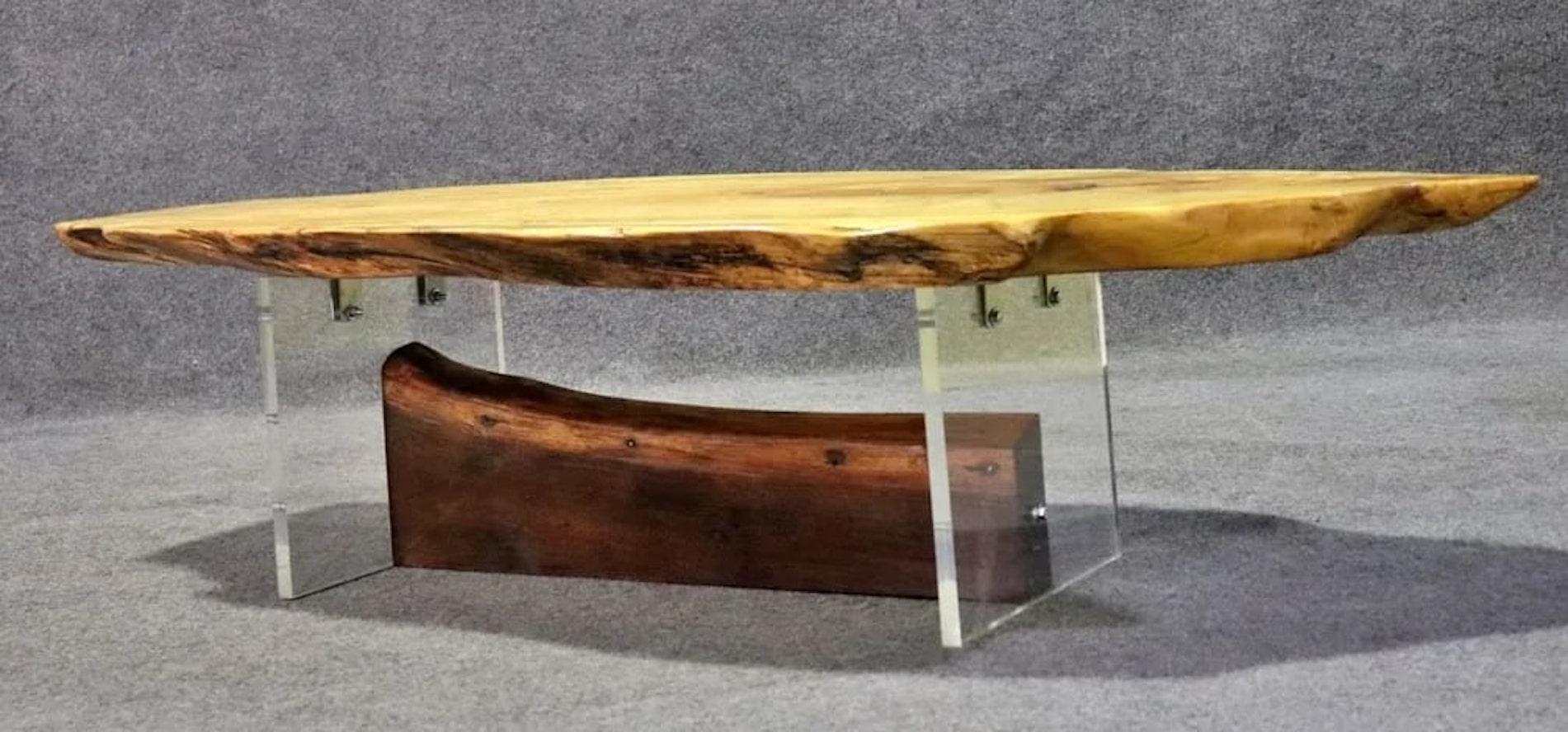 Unique artist made coffee table with live edge slab atop a clear acrylic base with wood runner.
Please confirm location NY or NJ