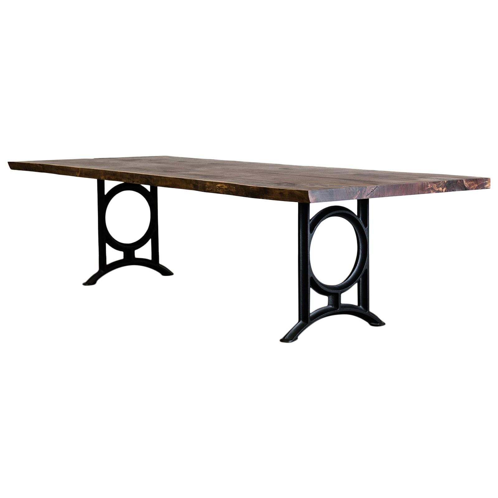 A solid bookmatch of figured black walnut from Oregon. Beautiful figuring in this piece with hand inlayed bowties. The cast iron base is our design and is shown here in black. The table will seat 10-12 people comfortably. 

It is finished with an