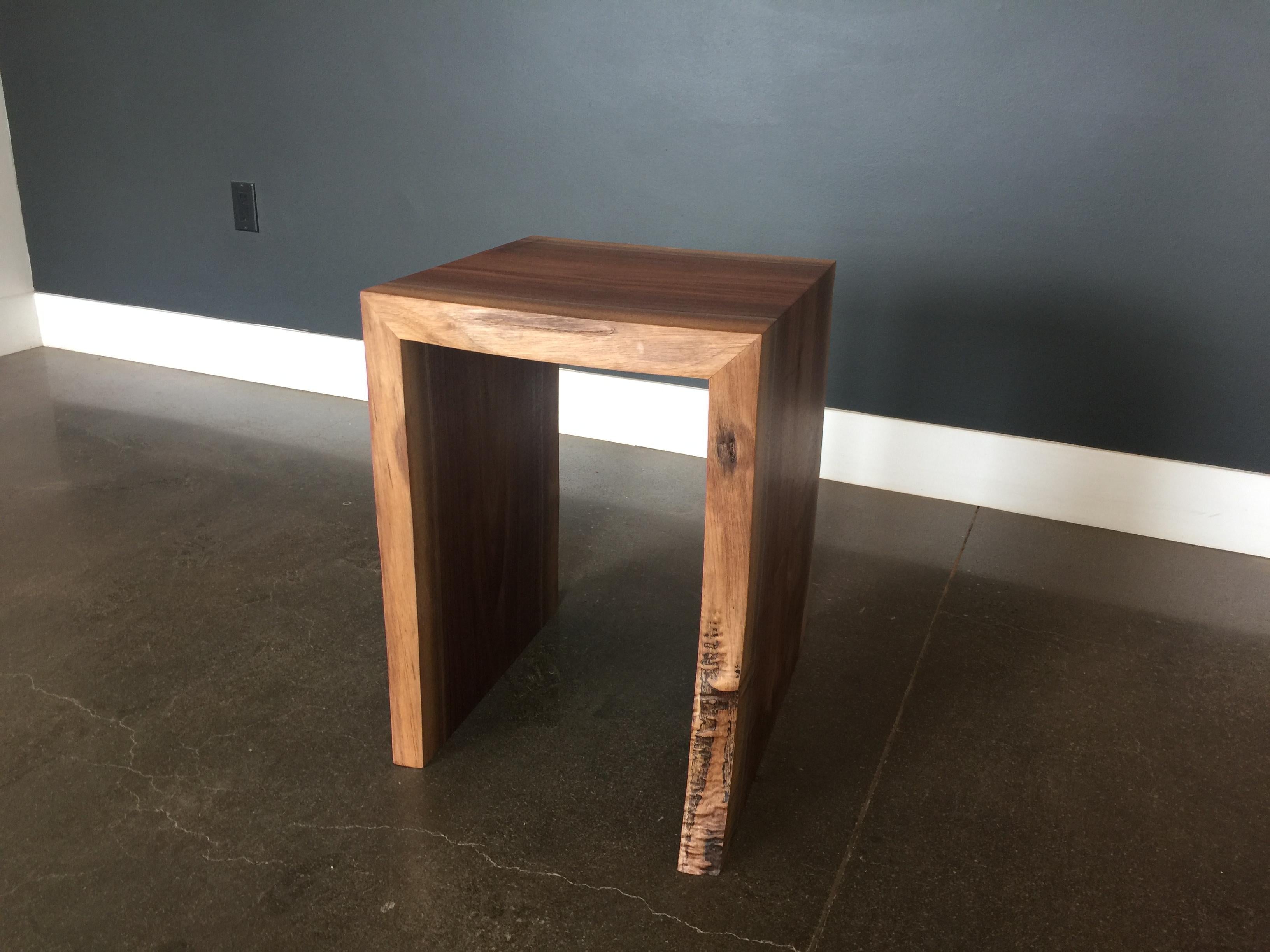 This coffee table is a live edge black walnut slab which was stained black. We have added 3 aluminum strips lengthwise. The legs are U shape aluminum base. We offer any color match stain. We make the sample and send it to you for approval. 

Bois &