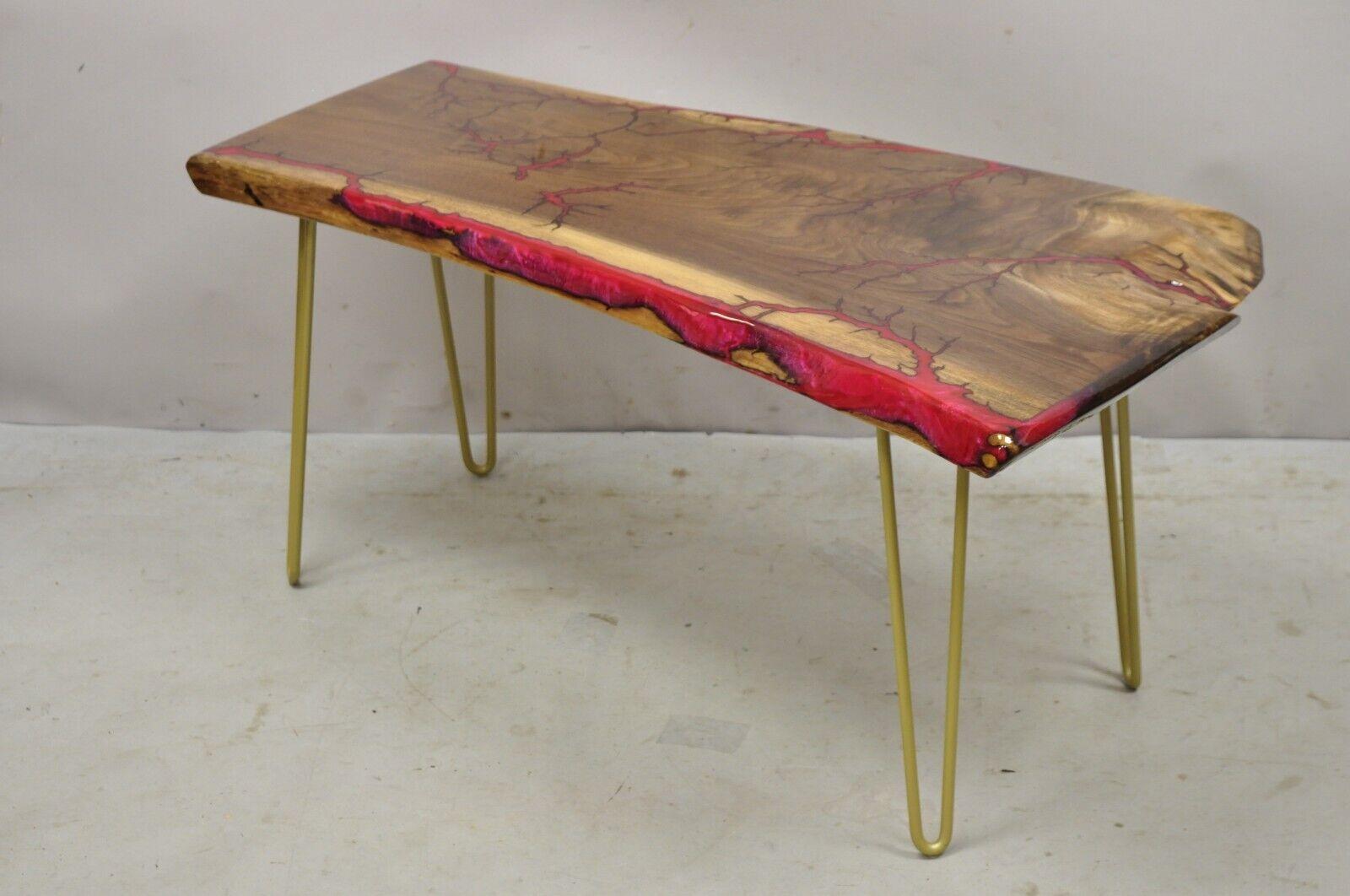 Live edge black walnut surfboard coffee table red resin lacquer hairpin legs. Item features gold metal hairpin legs, thick black walnut wood slab, red resin accents, lacquered finish, very nice item, great style and form. circa 21st century.