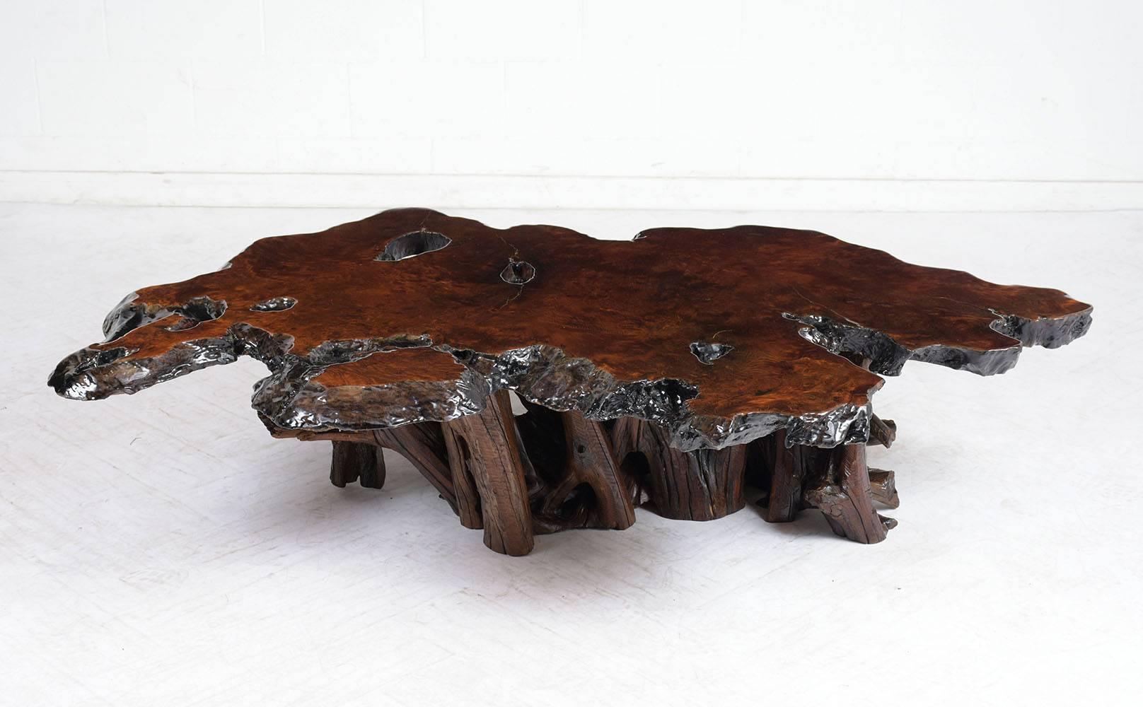 This 1960s coffee table has a unique shaped root base and live edge surface. The burl wood coffee table is finished in a rich, deep walnut color stain with a lacquered finish. This coffee table is sturdy, eye-catching, and ready to be used in any