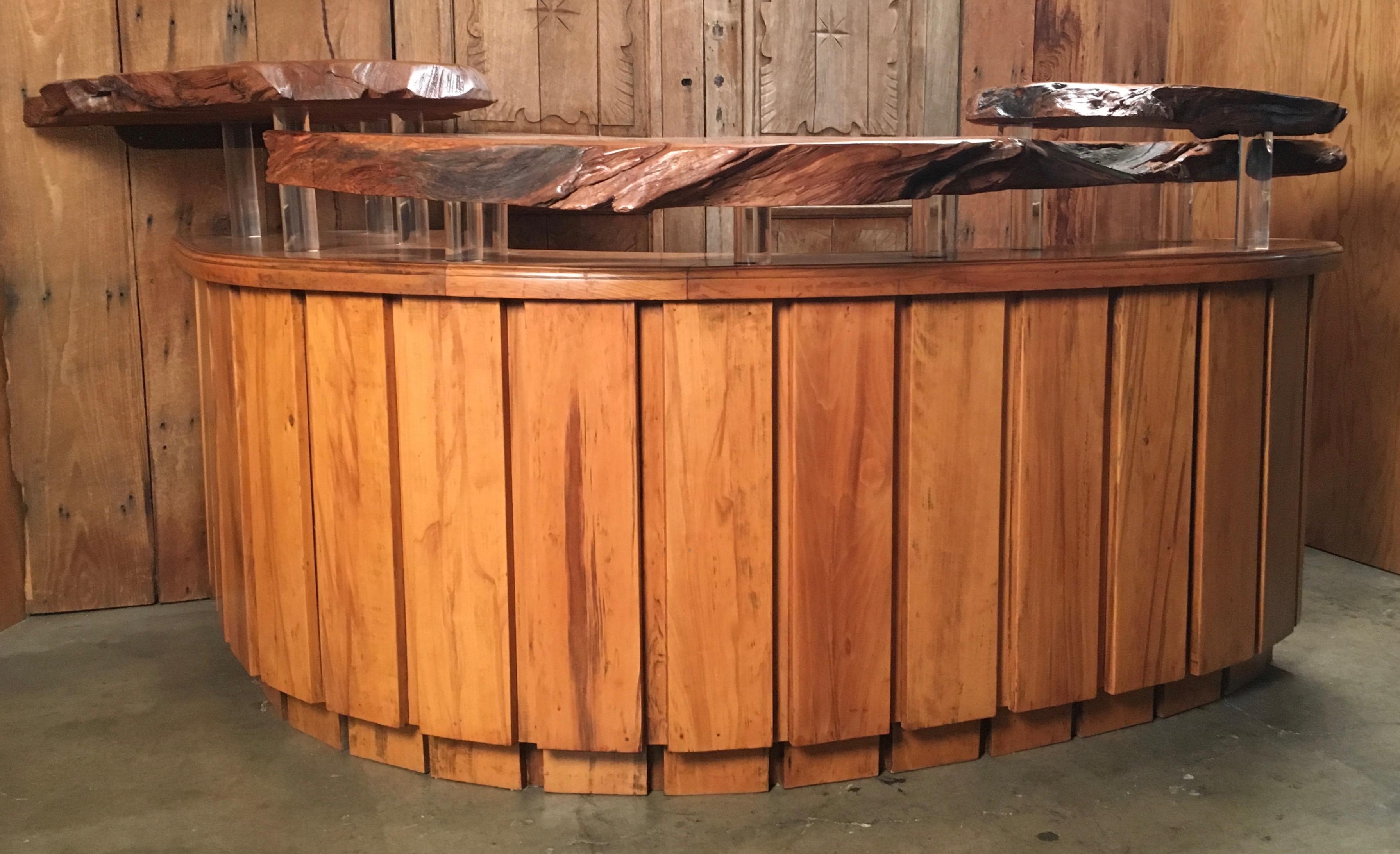 Floating live edge burl wood slabs atop Lucite columns on this handcrafted dry bar
with shelves, storage and a pullout / pull-out cutting board. L-shaped perfect for corners.