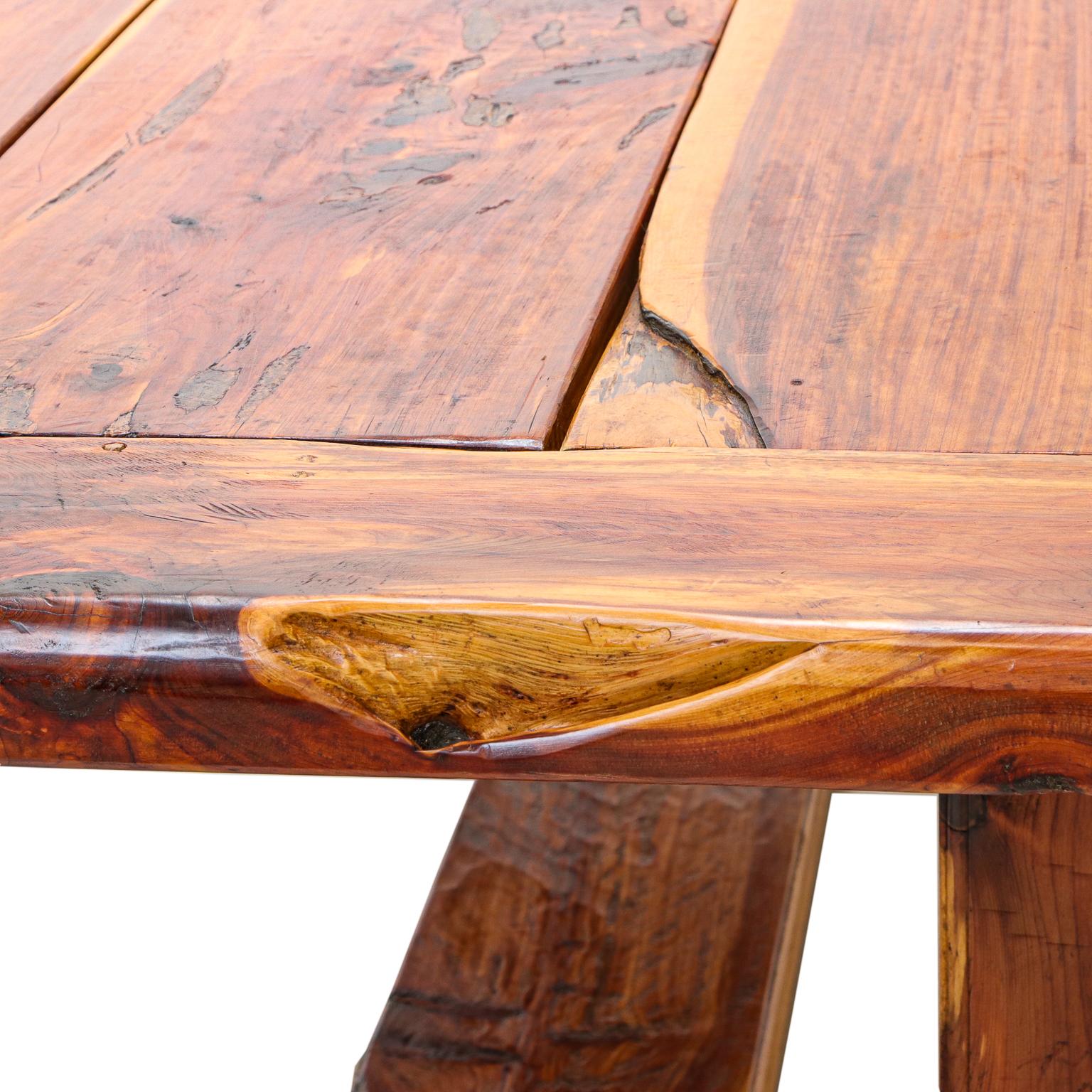 This live-edge cedar dining table which seats 10 people, was made in the beautiful mountains of East Tennessee all by hand and from raw materials. This cedar table is hand-made using no modern tools and was made in the living history
