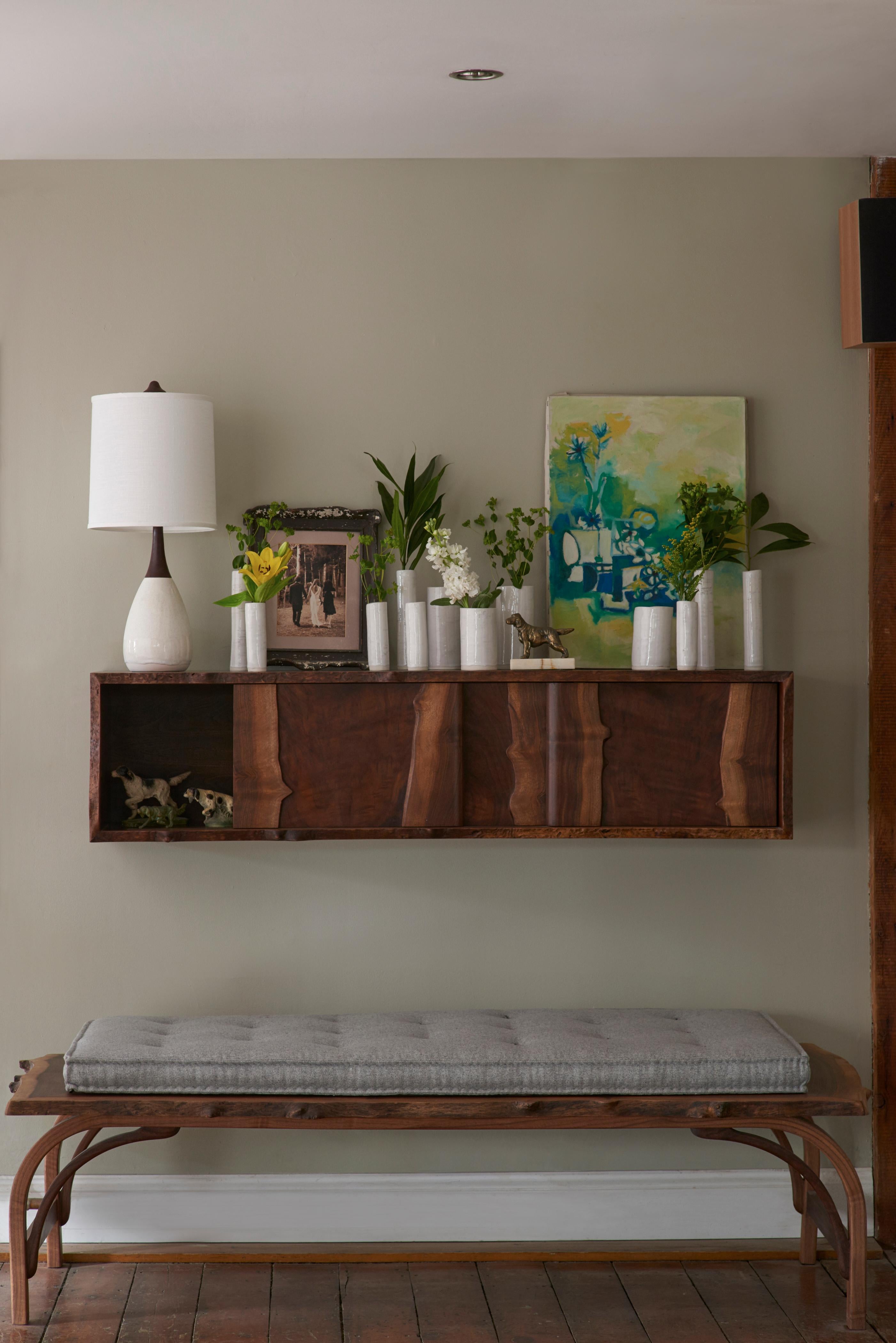 When floor space is limited hang it on the wall. Hang low below your flat screen TV, a bit higher in the dining room or entryway, or higher still combining mutiples as shelving. This piece features highly figured live edge claro walnut with three