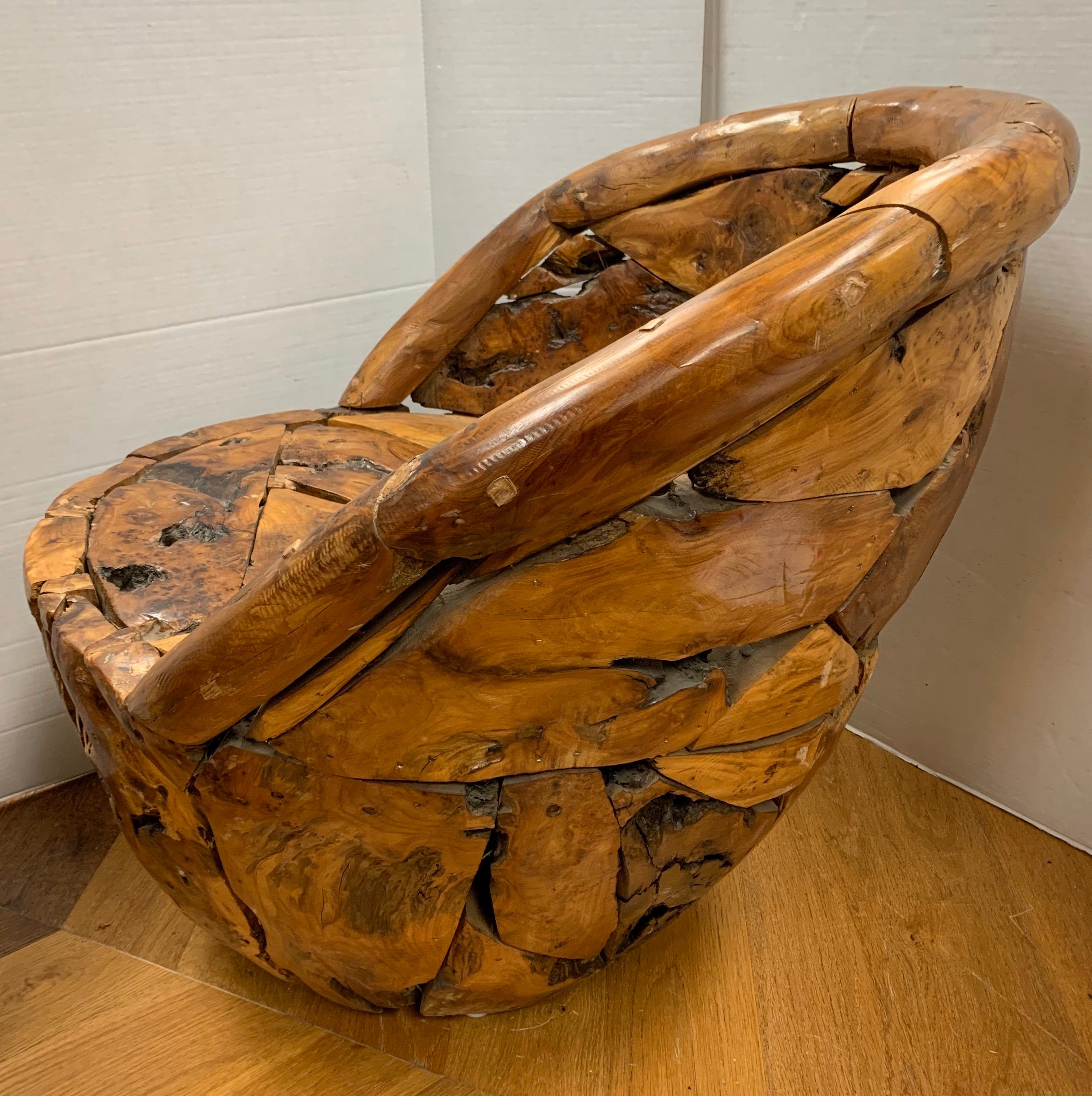 Unique club chair made of a teak root wood pieced together to form a circular seat and round back. Definitely a statement piece that would look great in any room.