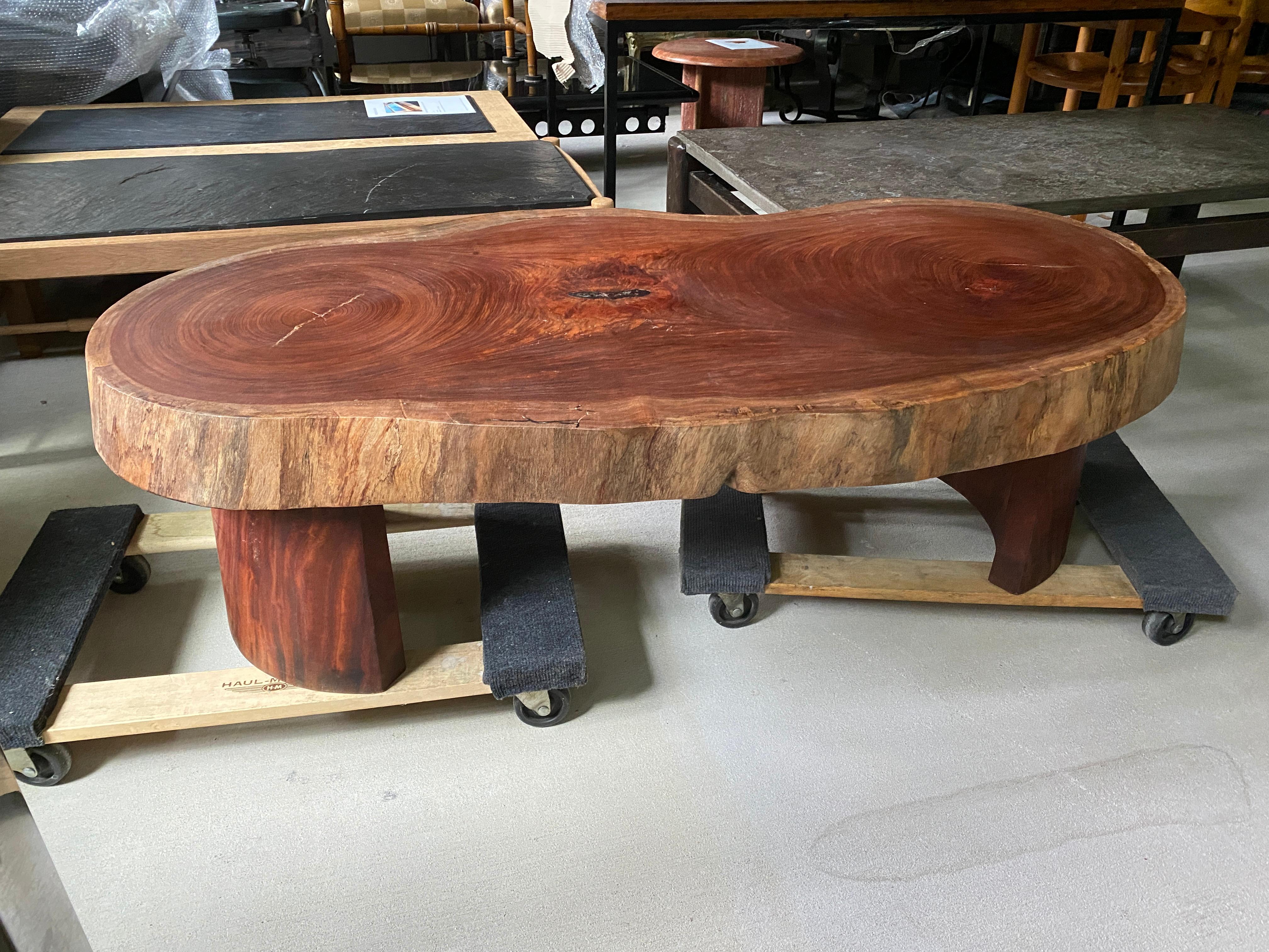 Solid four inch slab of mahogany in matte finish with arched legs. Mid-Century Modern meets organic modern, from Belgium, 1960s.