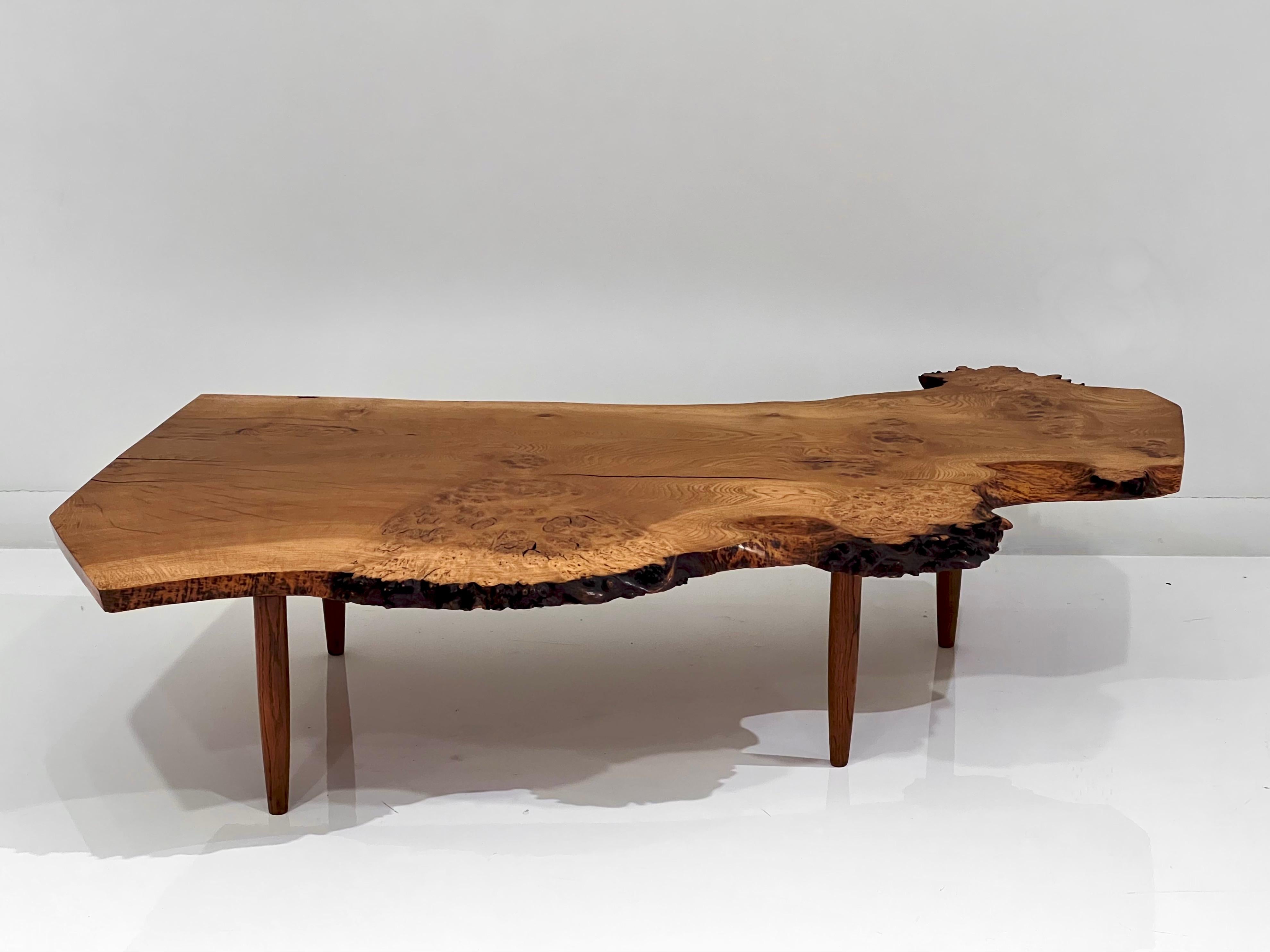 Phenomenal live edge coffee table by George Nakashima. circa 1960s with an organic walnut burl flow.
Approximate overall dimensions: 58