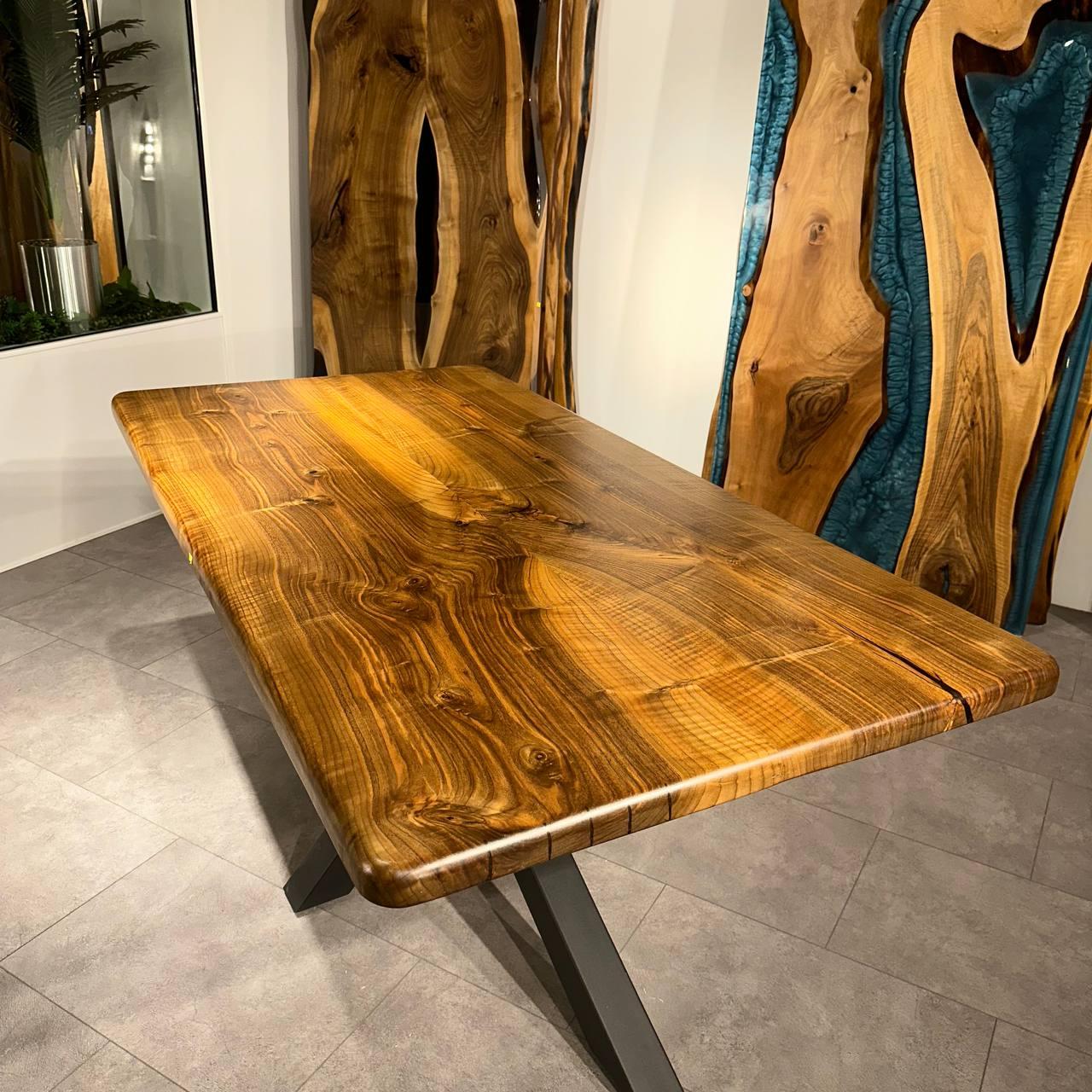 LIVE EDGE CUSTOM WALNUT DINING TABLE

This table is made of natural walnut slabs. 

Some Walnut slabs have a lot of natural beauty as it’s one side has a large curve. This is one of them! 

We've filled the cracks with black epoxy, without