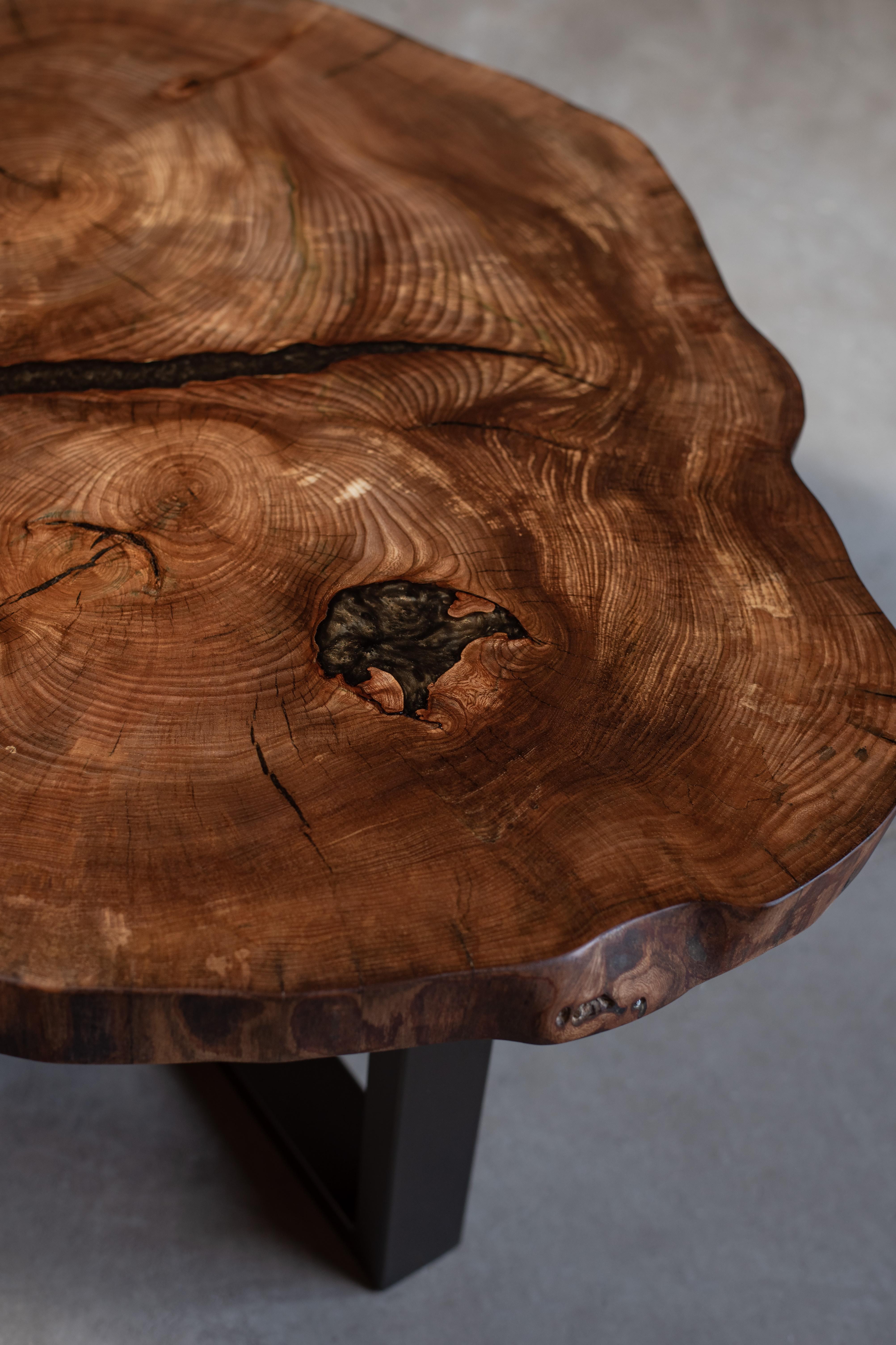 Live edge elm coffee table with epoxy resin details.
Dark bronze powder-coated steel base.

The coffee table is available immediately.