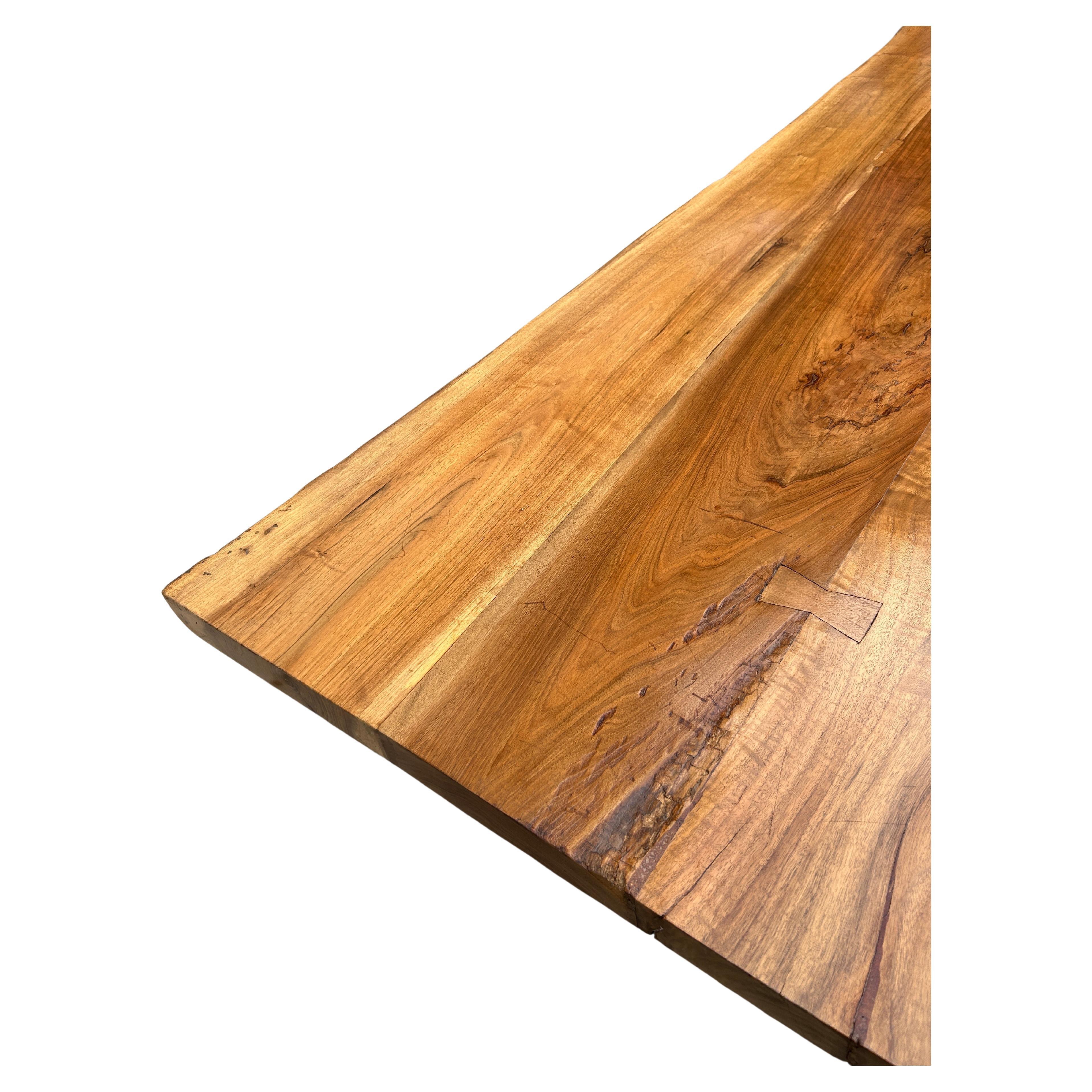 Beautiful live edge hardwood slab dining table the style of Nakashima. thick slab with live edges on both sides and butterfly joints. The table measures 80
